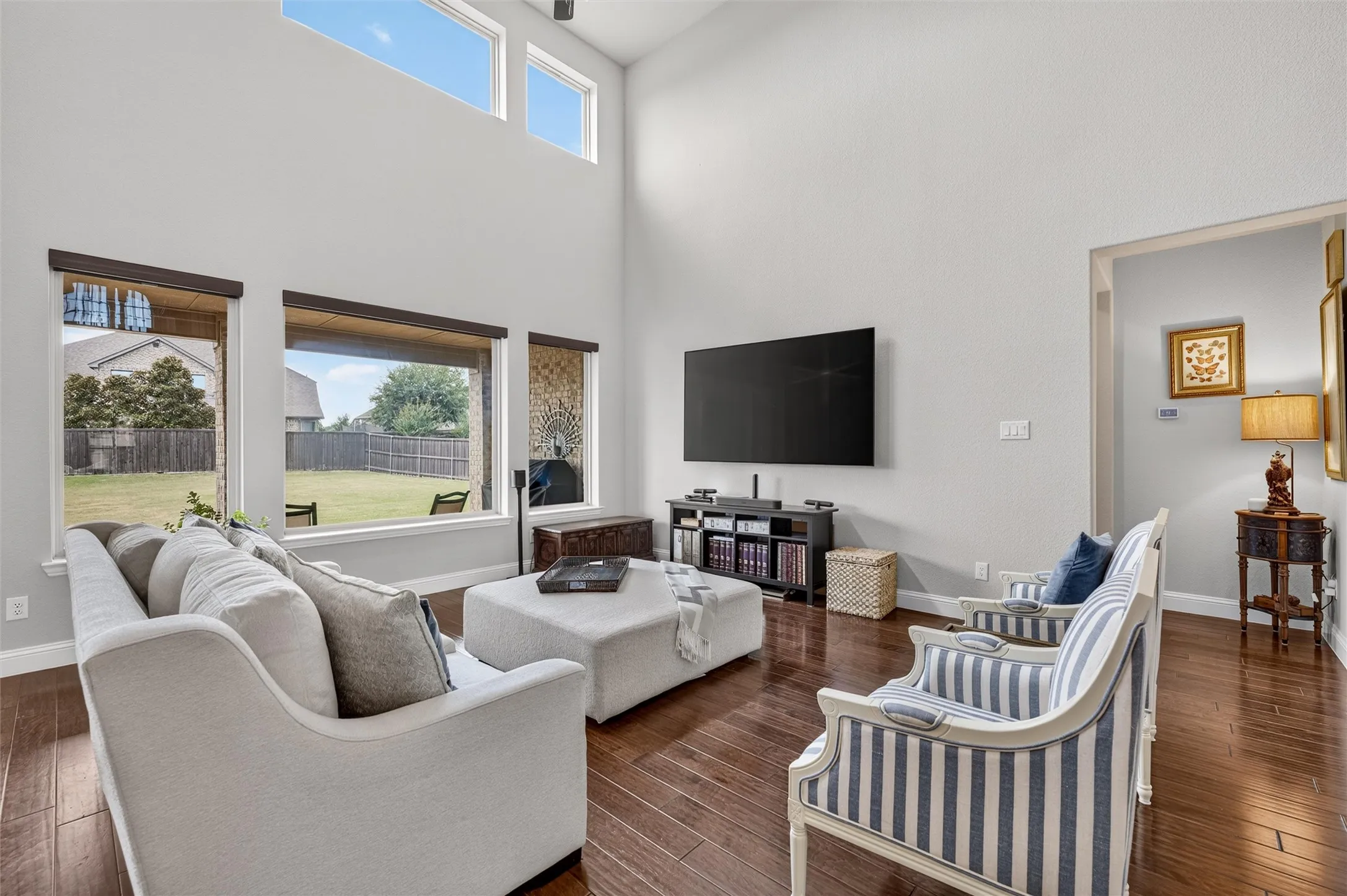 Soaring ceilings, rich wood-finish flooring, and expansive windows
