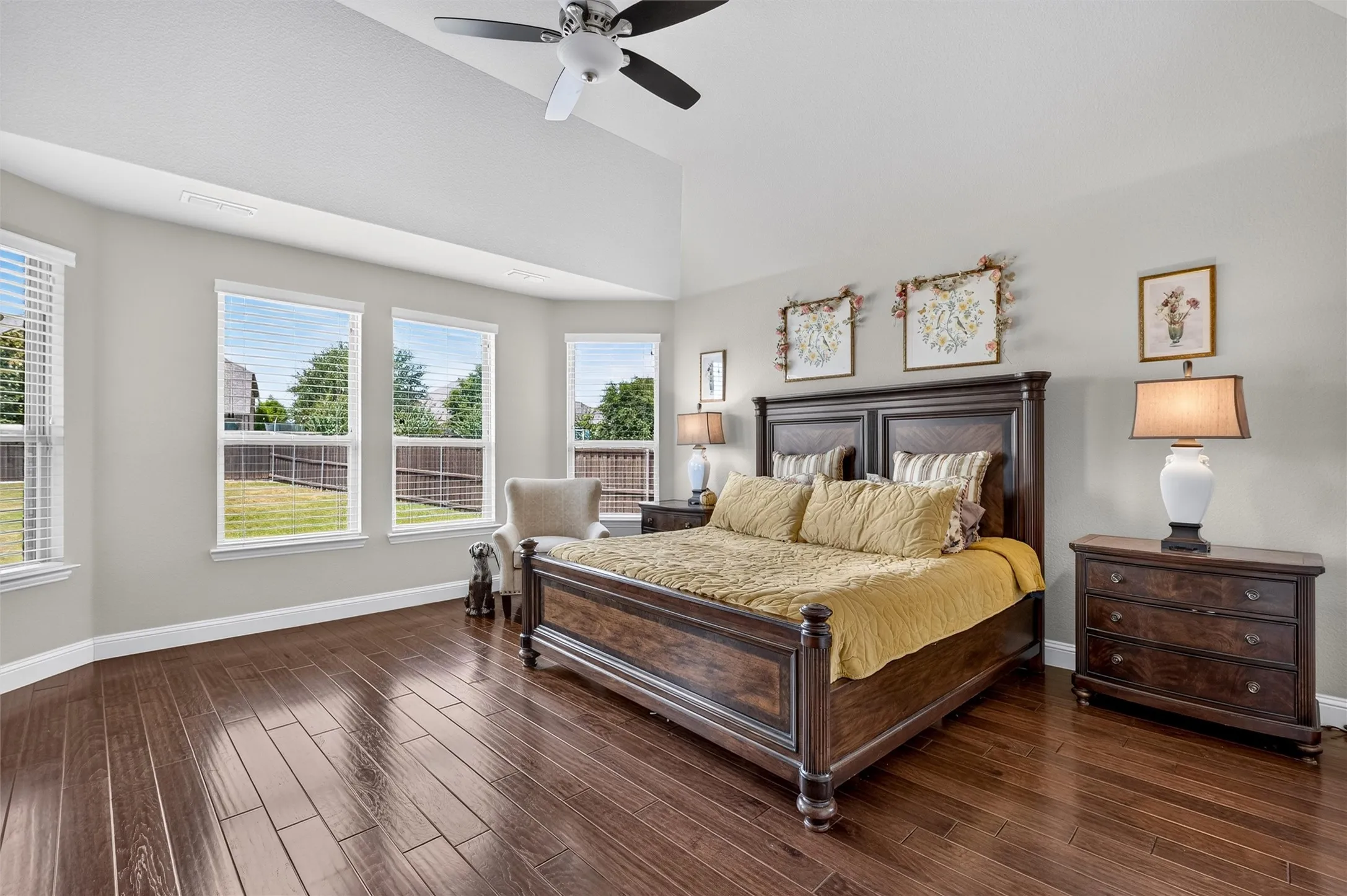 Wood-finish flooring, vaulted ceiling, and a ceiling fan