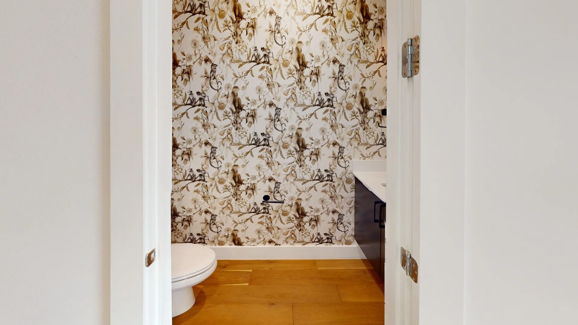 Hardwood flooring, wall-mounted vanity, patterned wallpaper