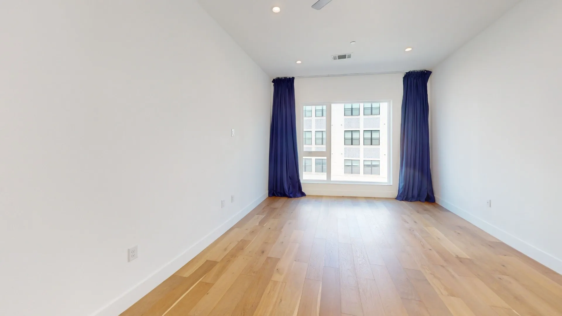 Hardwood-finish flooring, recessed lighting, expansive window, and high ceilings