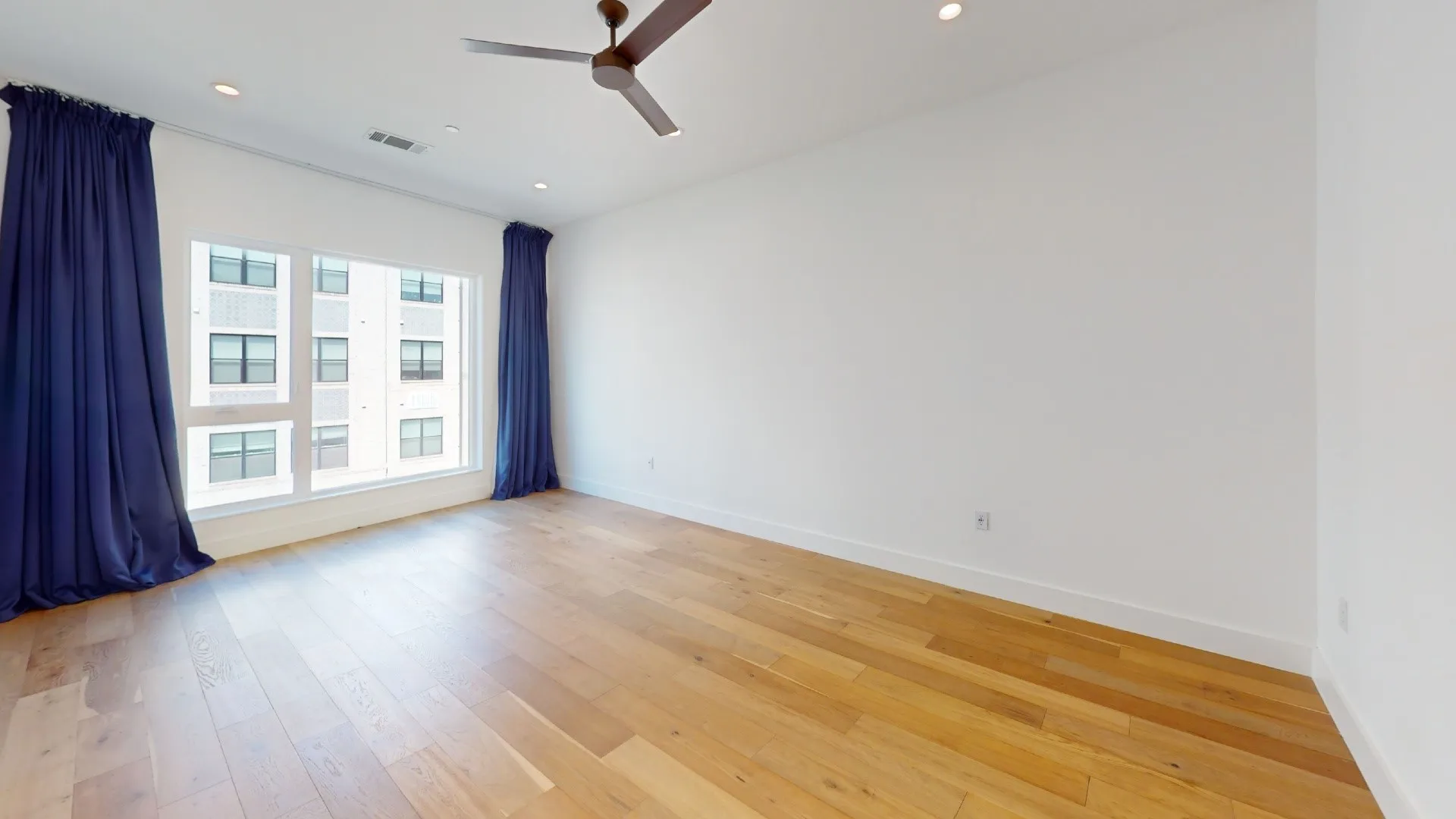 Hardwood flooring, recessed lighting, and a ceiling fan