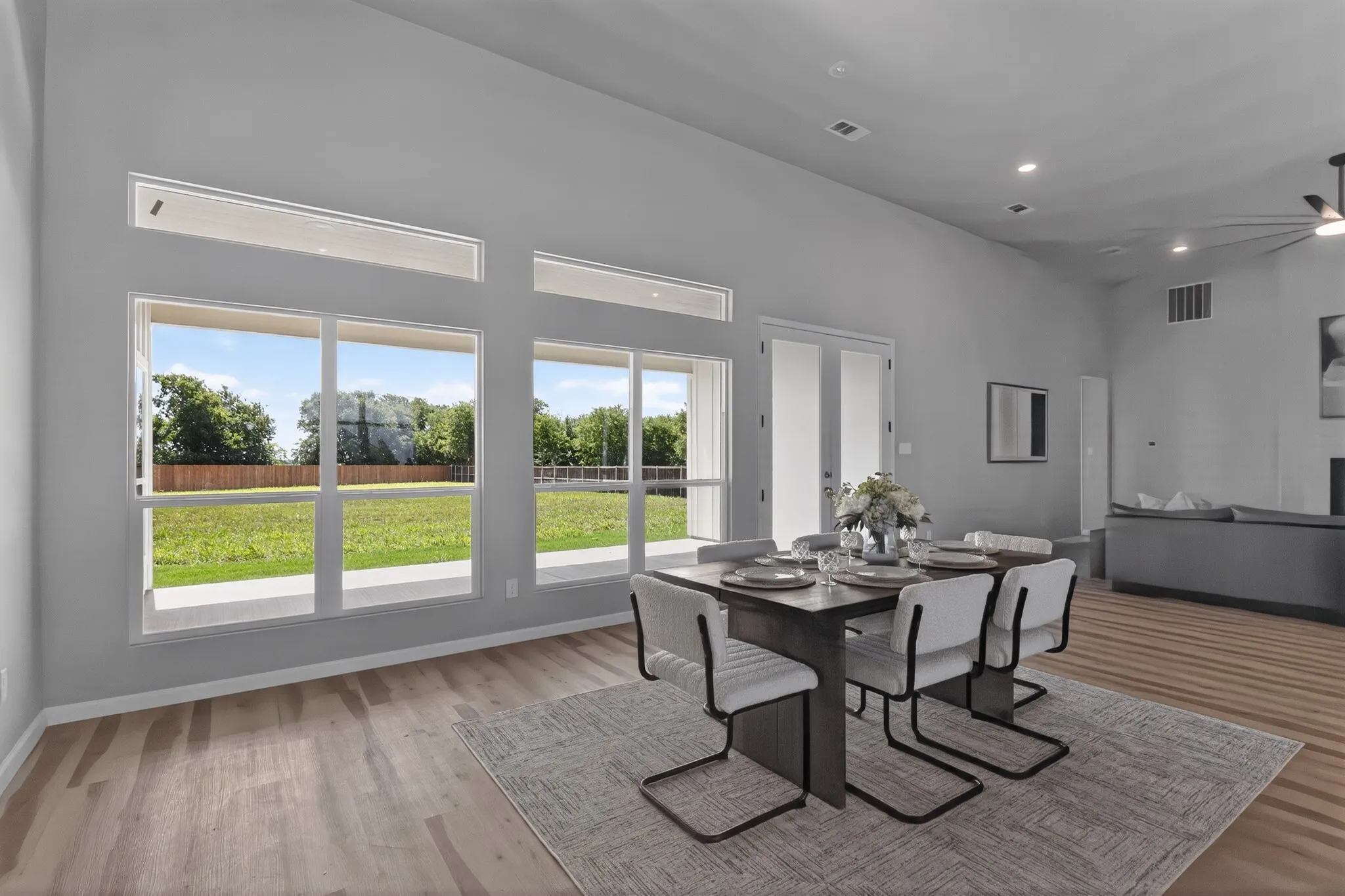 Spacious dining area featuring wood-finish flooring, vaulted ceilings, and recessed lighting