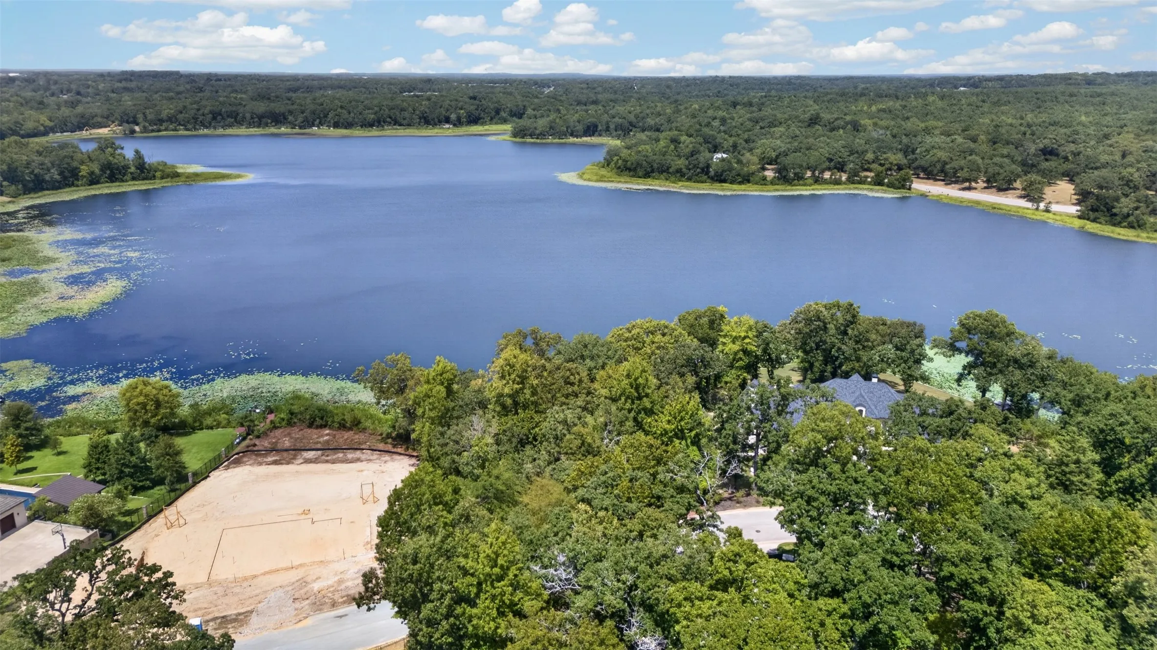Expansive lake frontage with extensive tree coverage