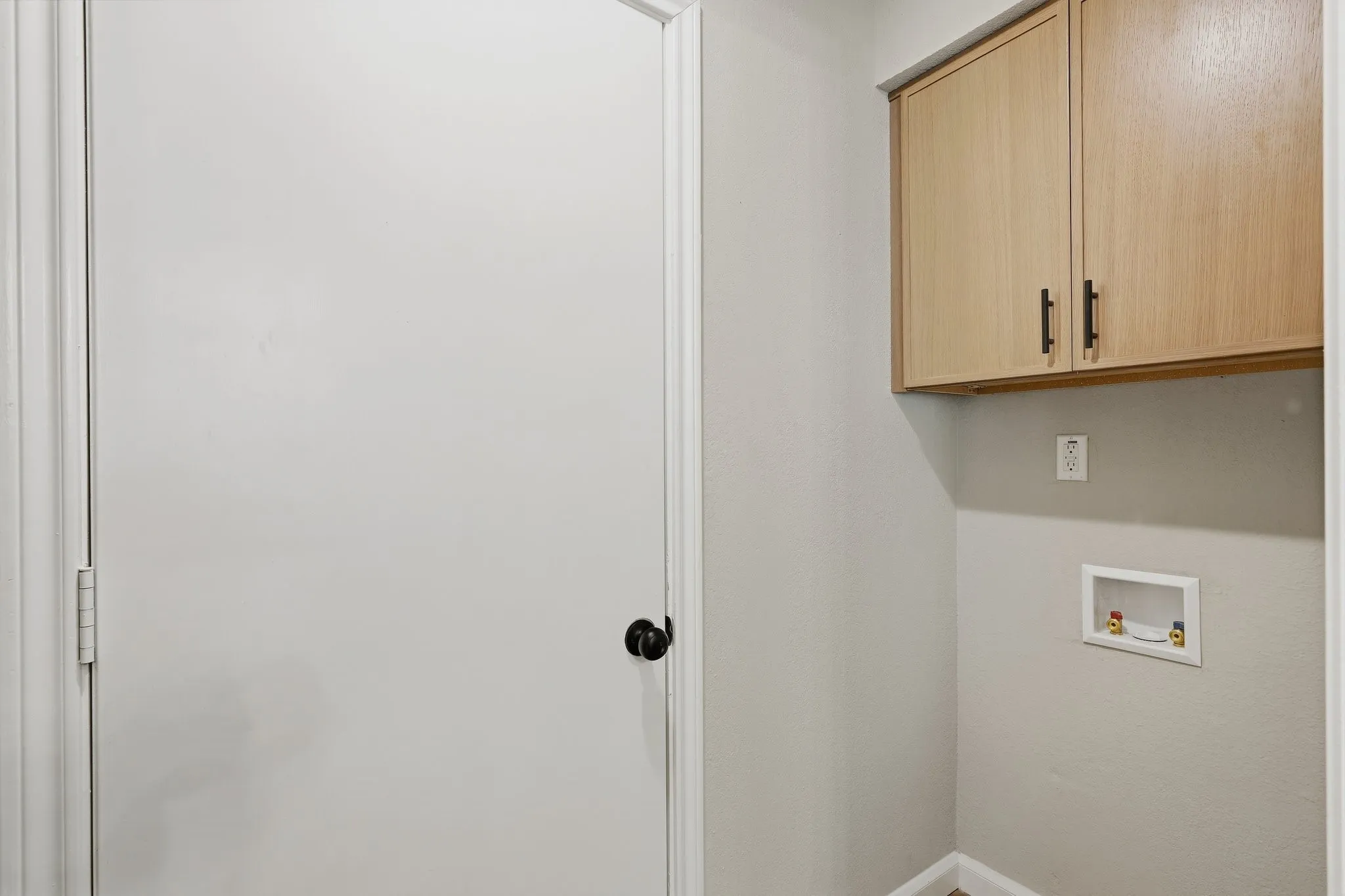 Wall-mounted cabinetry with matte black hardware