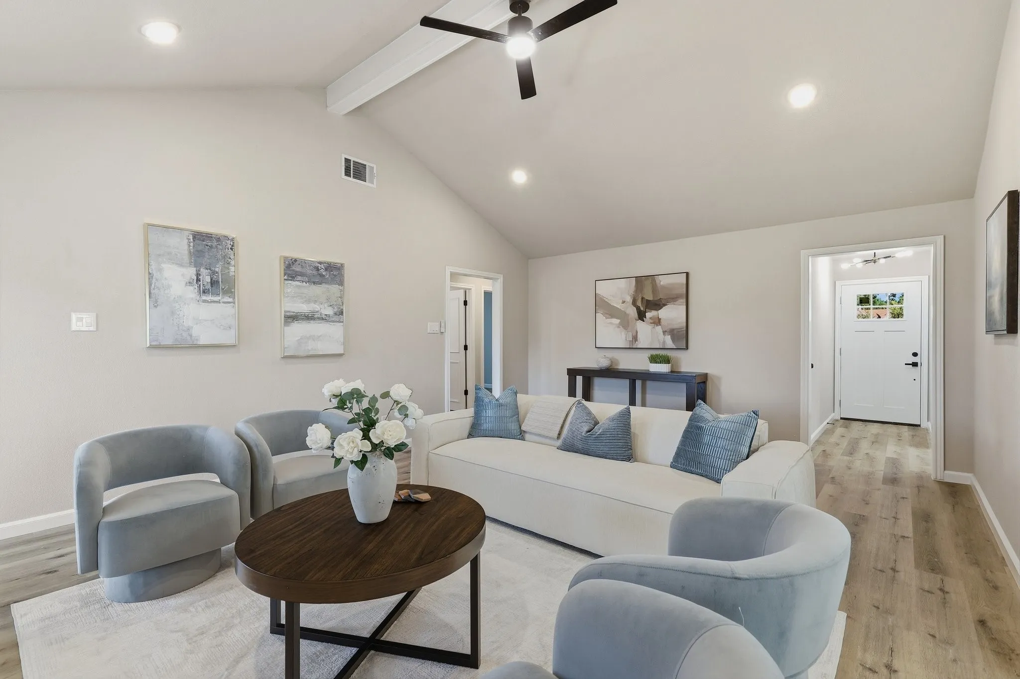 Vaulted ceiling with exposed beam, recessed lighting, wood-finish flooring, and a contemporary ceiling fan