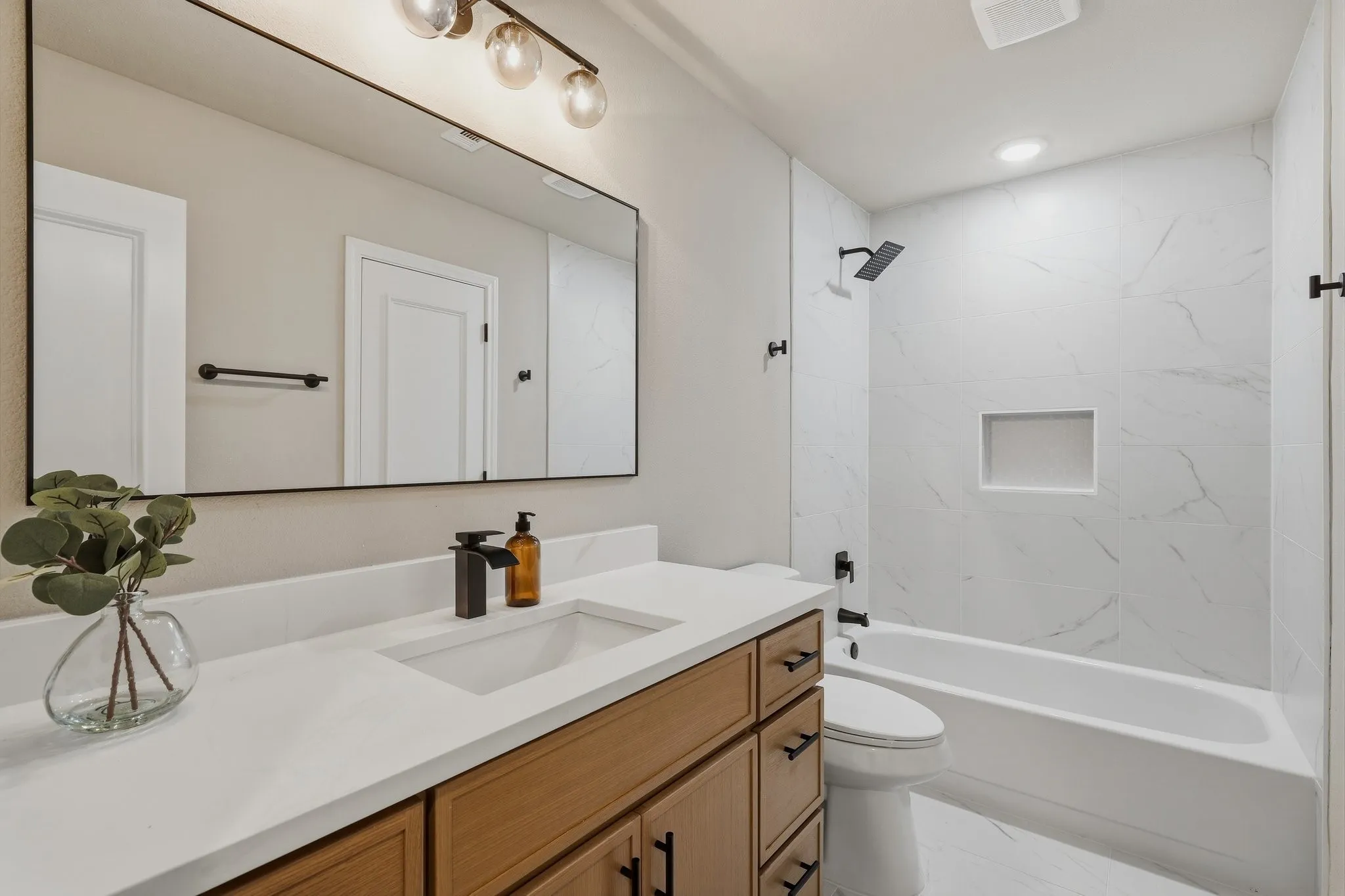 Modern vanity with an integrated sink and wood-finish cabinetry