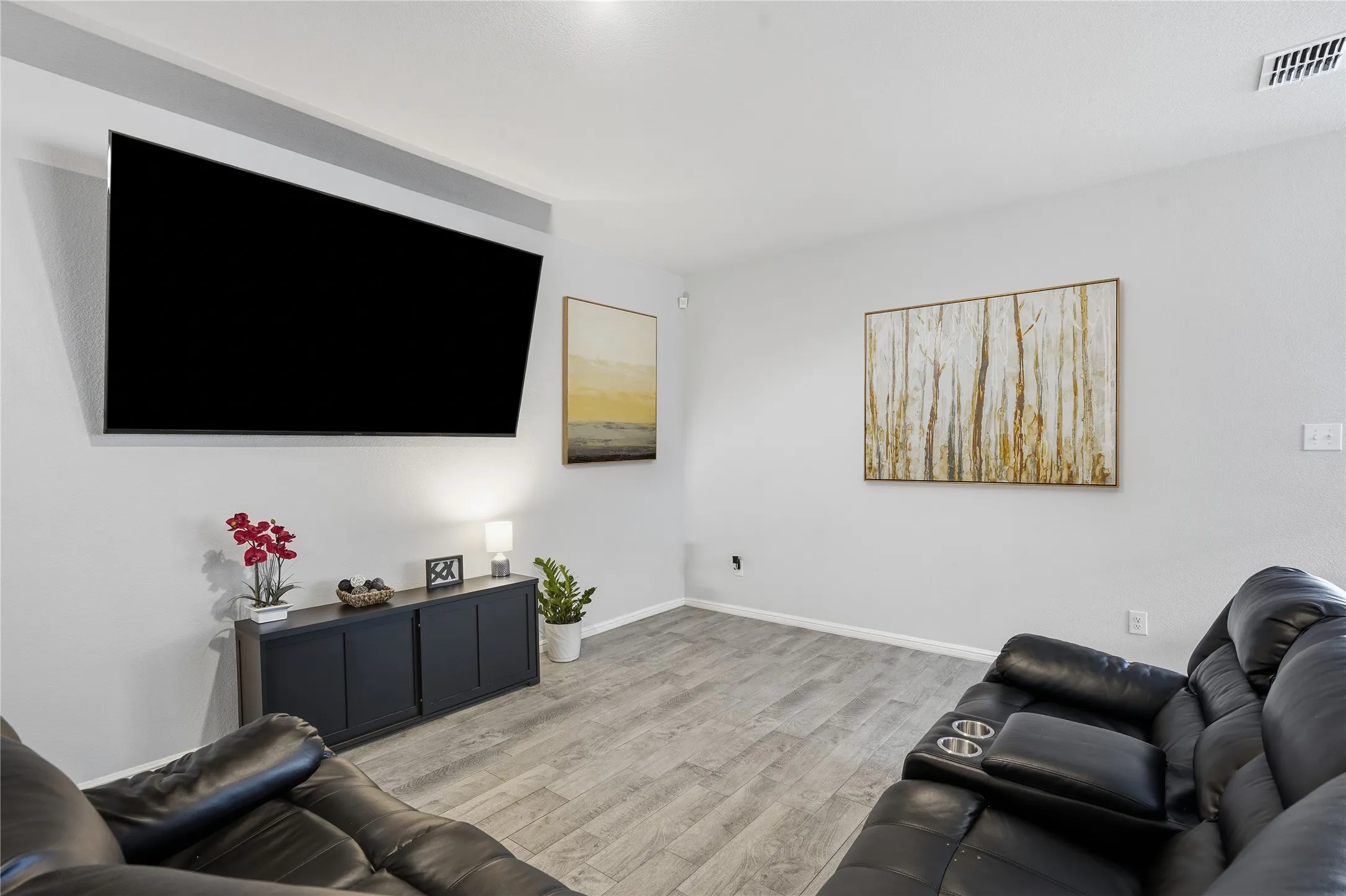 Neutral-toned interior space featuring wood-finish flooring and smooth wall textures