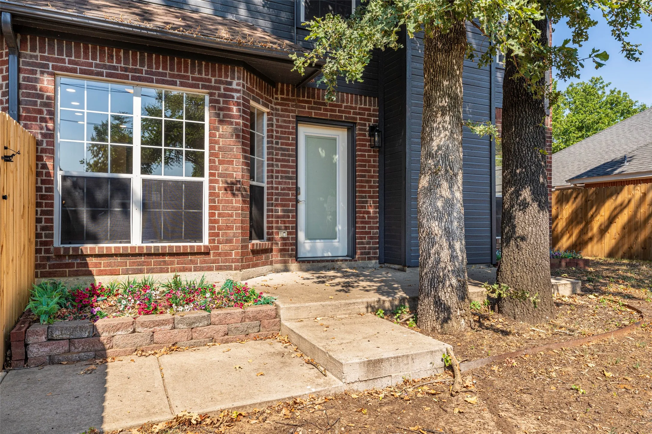 Brick exterior with a prominent bay window featuring grid-patterned panes