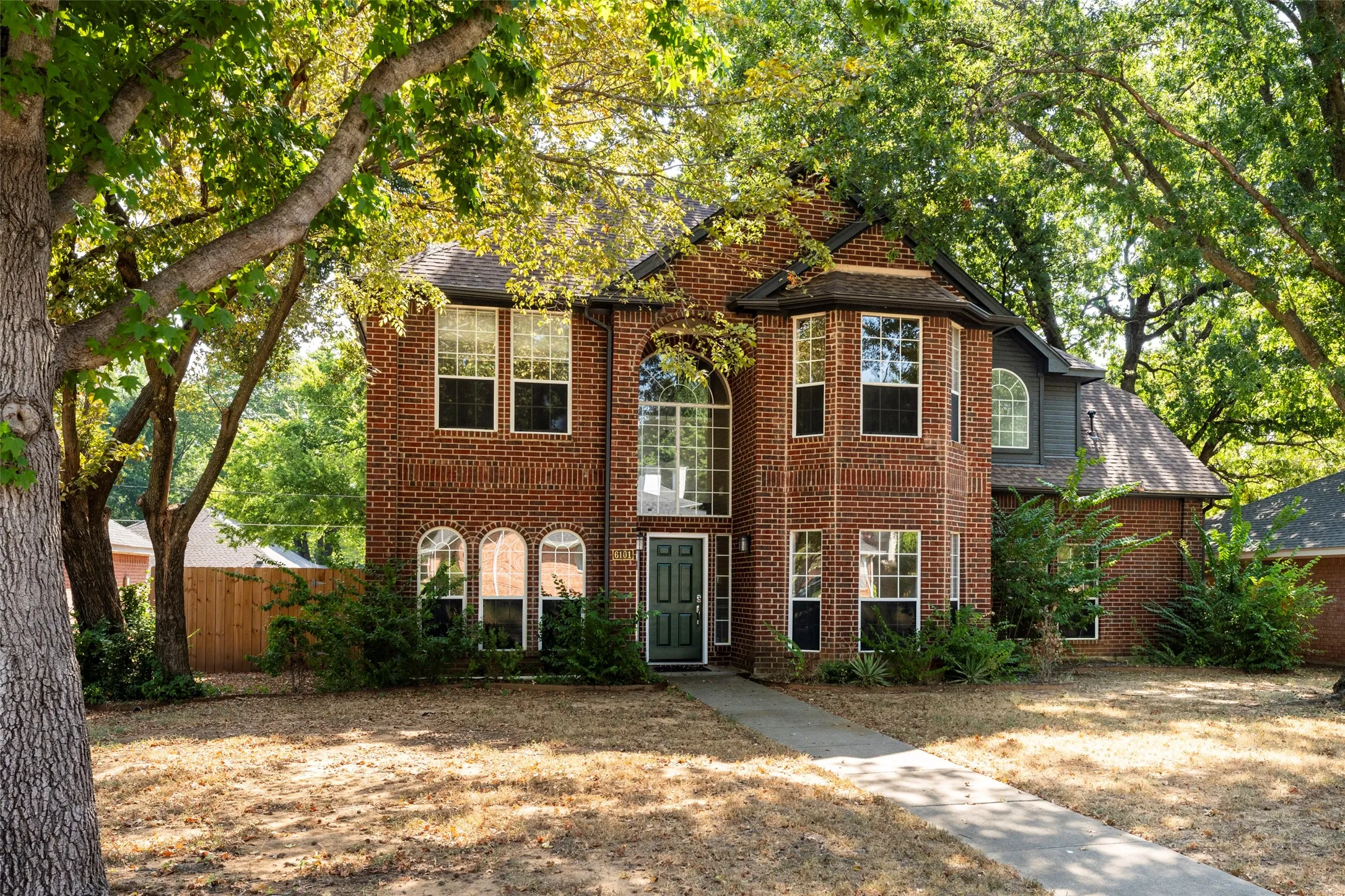 Brick exterior with a prominent bay window feature
