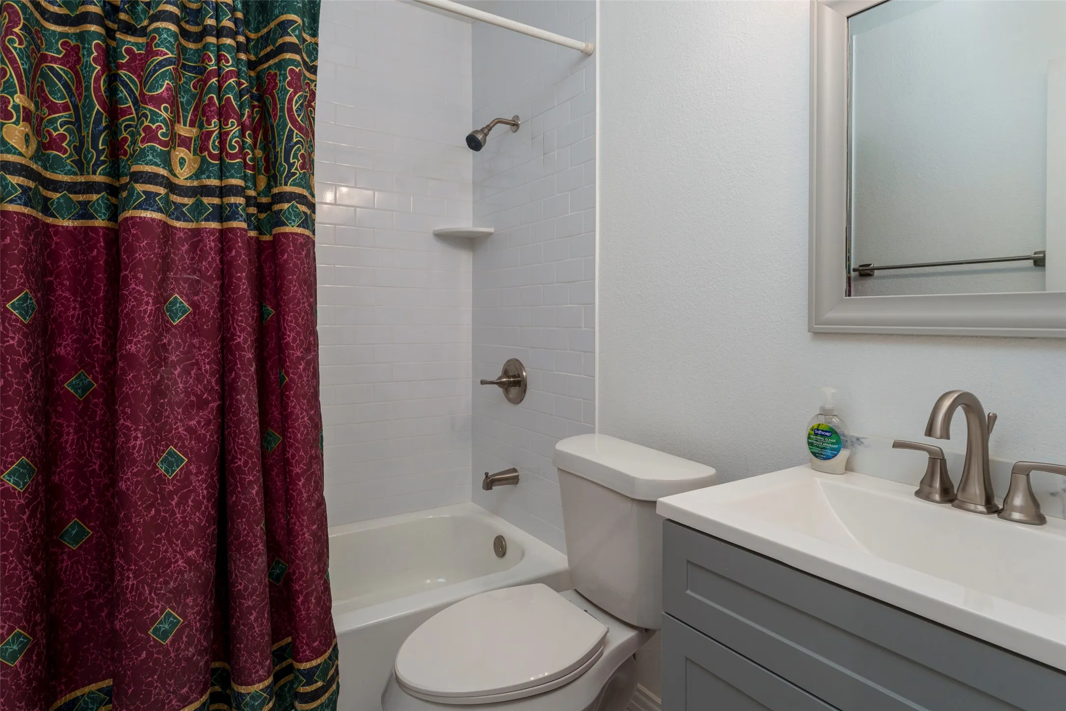 White subway tile shower surround with integrated soap dish