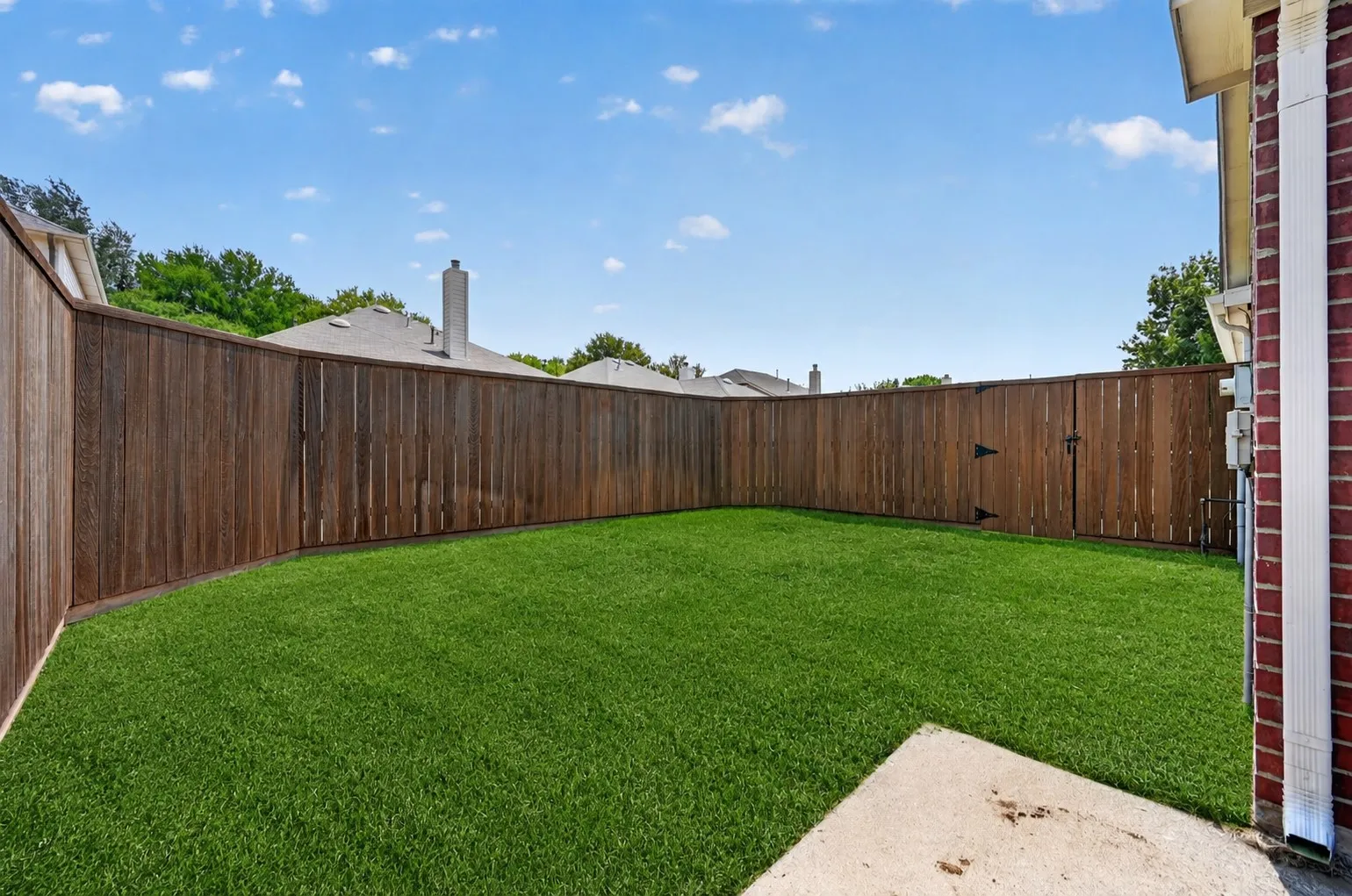 Private fenced yard featuring a concrete patio and a gated entry