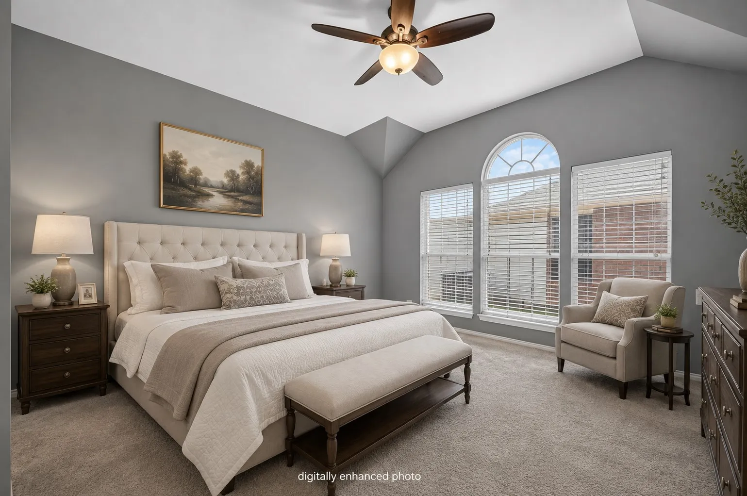 Vaulted ceilings with a ceiling fan, carpeted flooring, and a large arched window