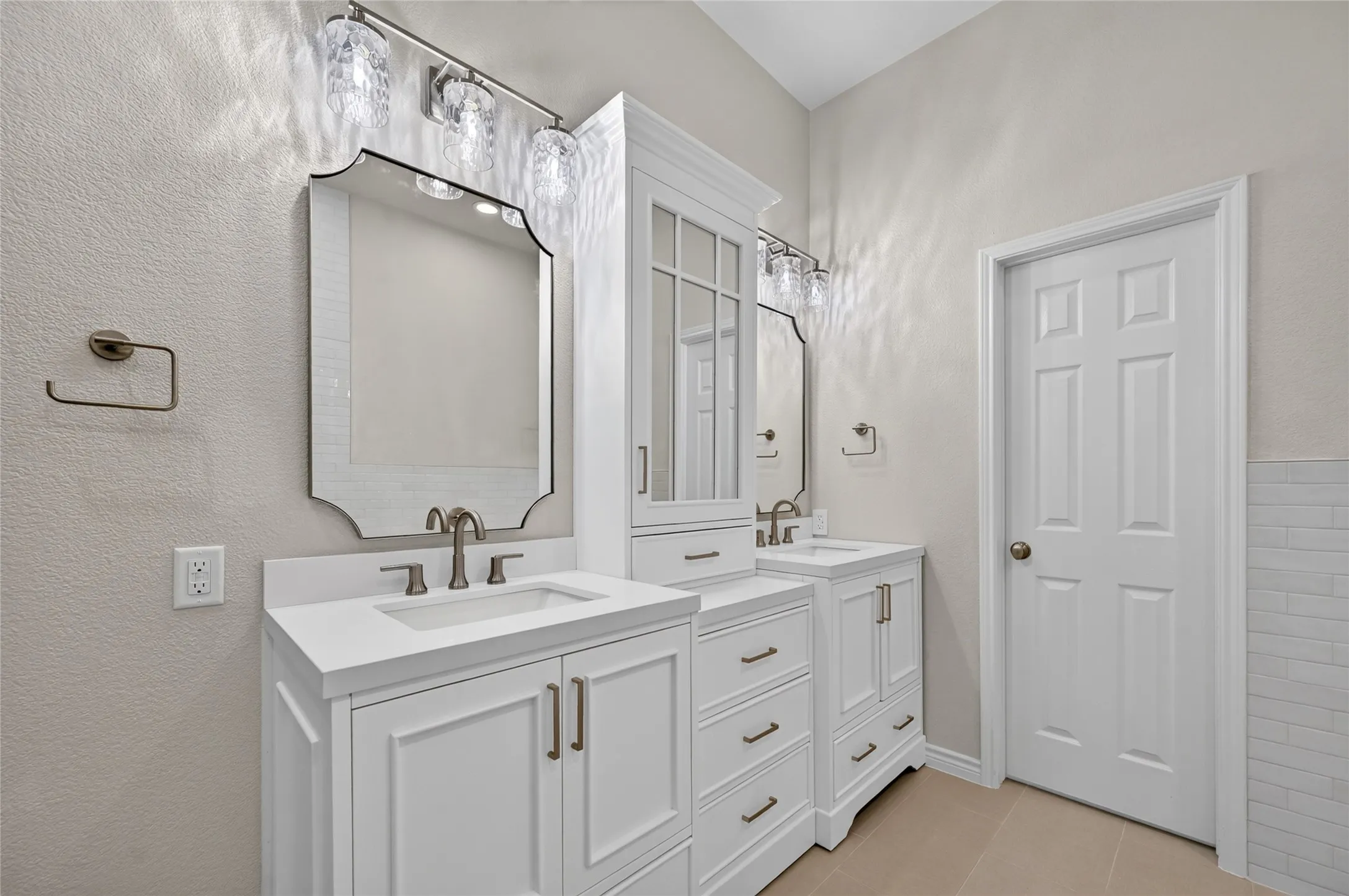 Dual vanity with white cabinetry, integrated sinks, white countertops, and brushed nickel fixtures