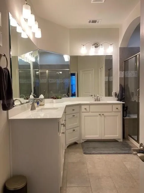 Dual vanity with white cabinetry and light-toned countertops