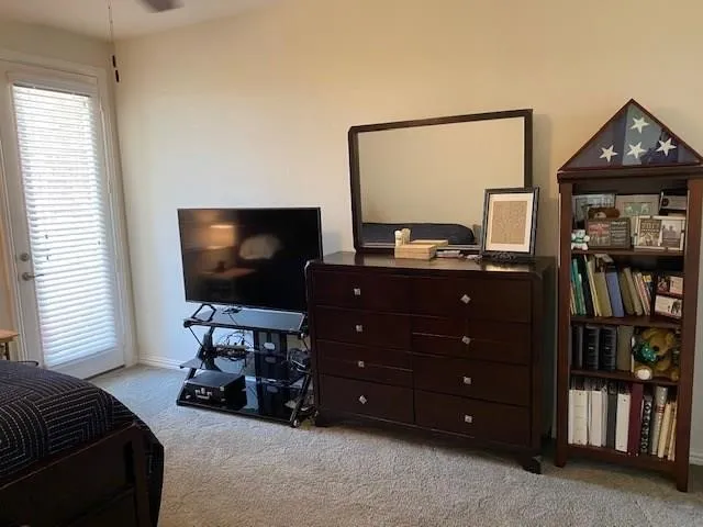 Wall-to-wall carpeting and a ceiling fan are present