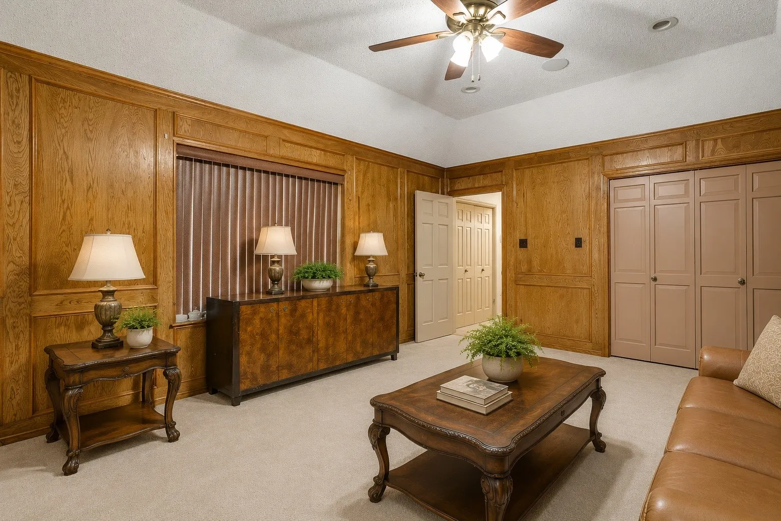 Wood paneling, ceiling fan, carpet flooring, recessed lighting, and built-in closet storage (Virtually staged & edited)