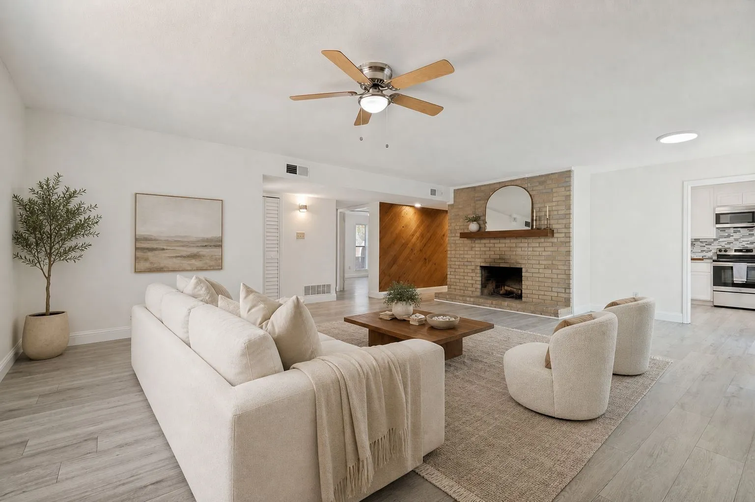 Large living room with a brick fireplace *virtually staged*