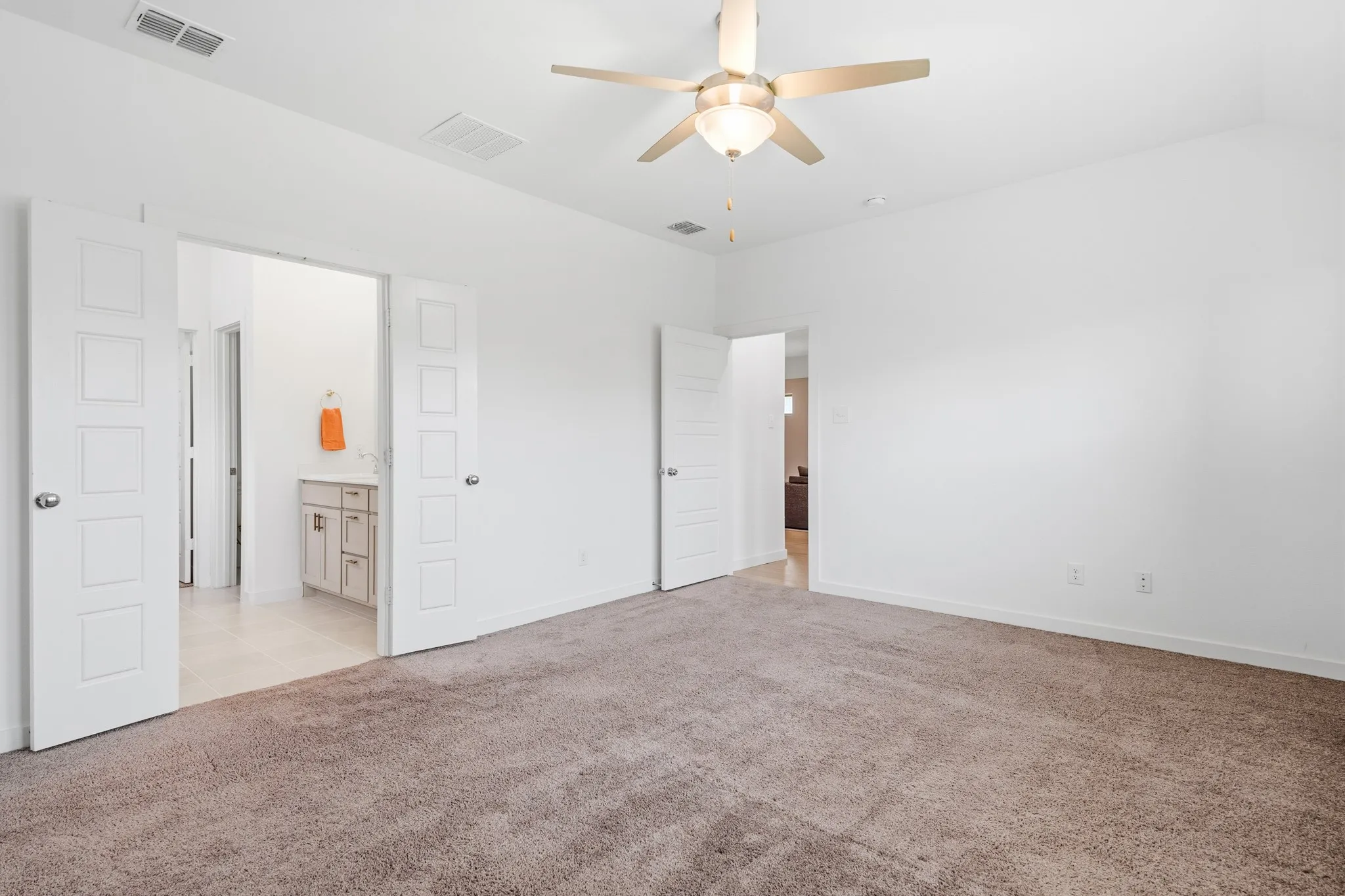 This primary is tucked on the backside of the home separate from the other rooms for extra privacy and has a full ensuite of its own to enjoy.