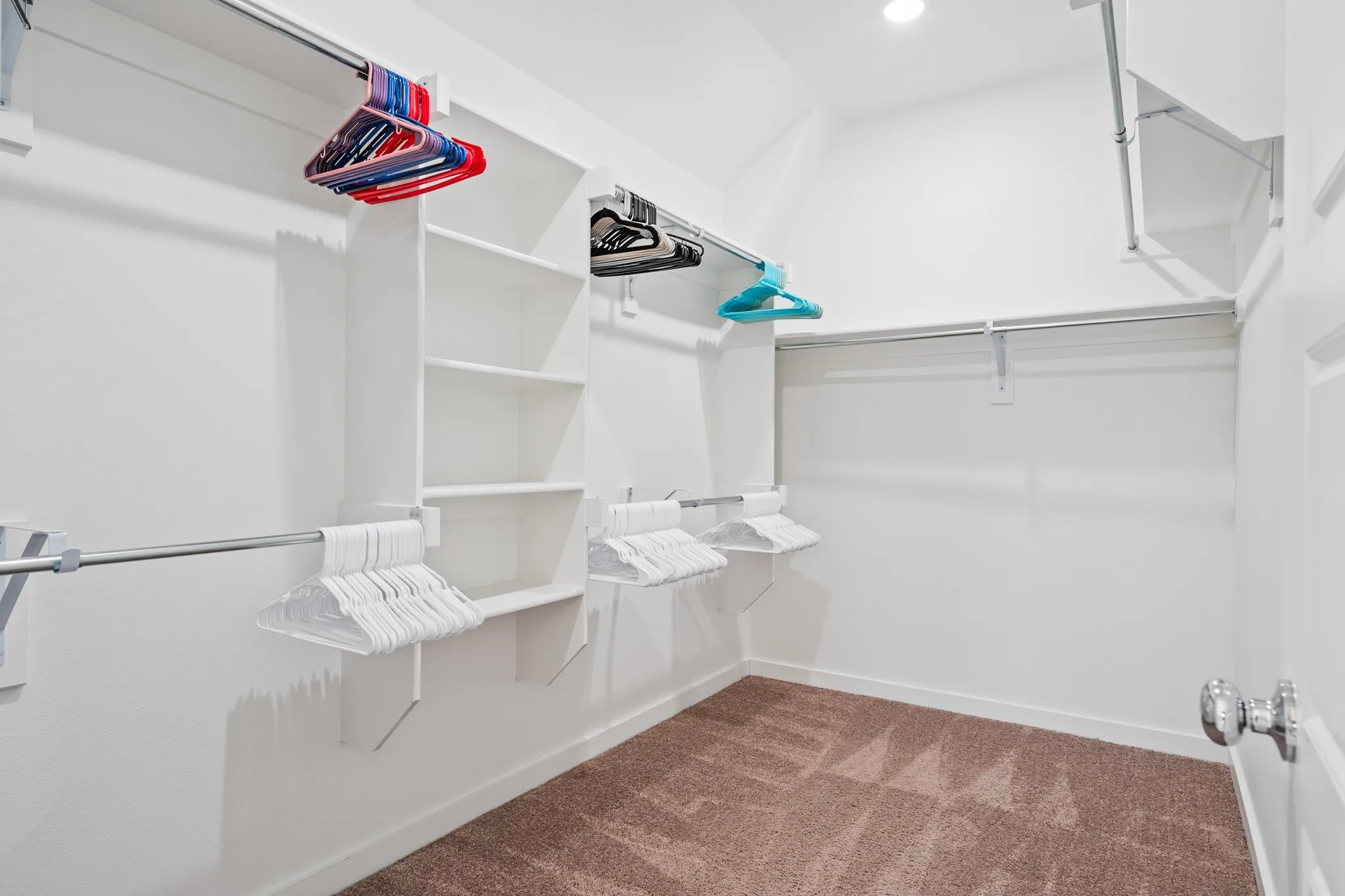 This walk-in closet has built in shelves, rows & rows to hang your clothes and a good amount of space to put all the shoes, hats, purses galore.