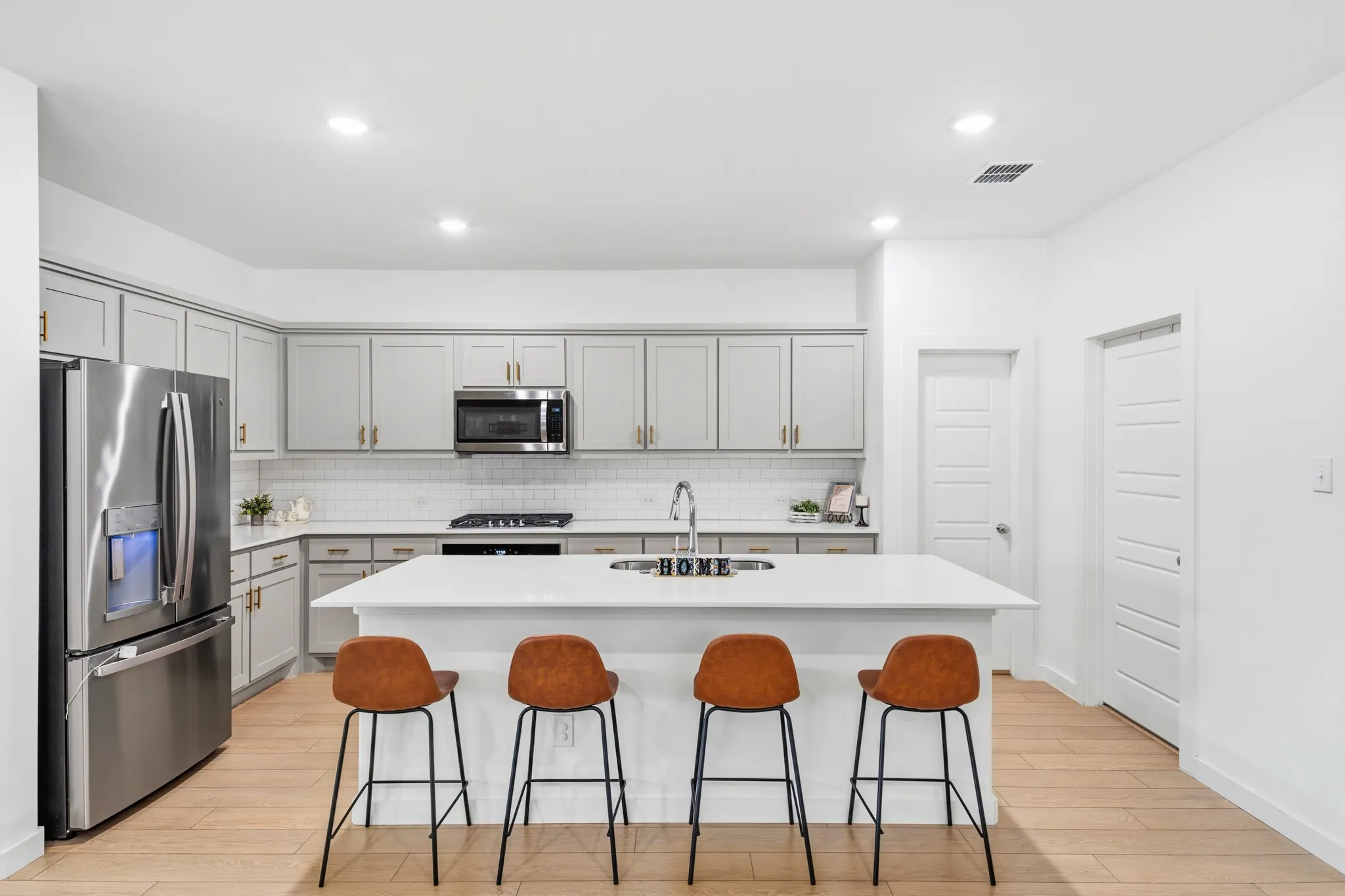 If the 8-seat table isn't enough, the kitchen island has room for 4 more.
