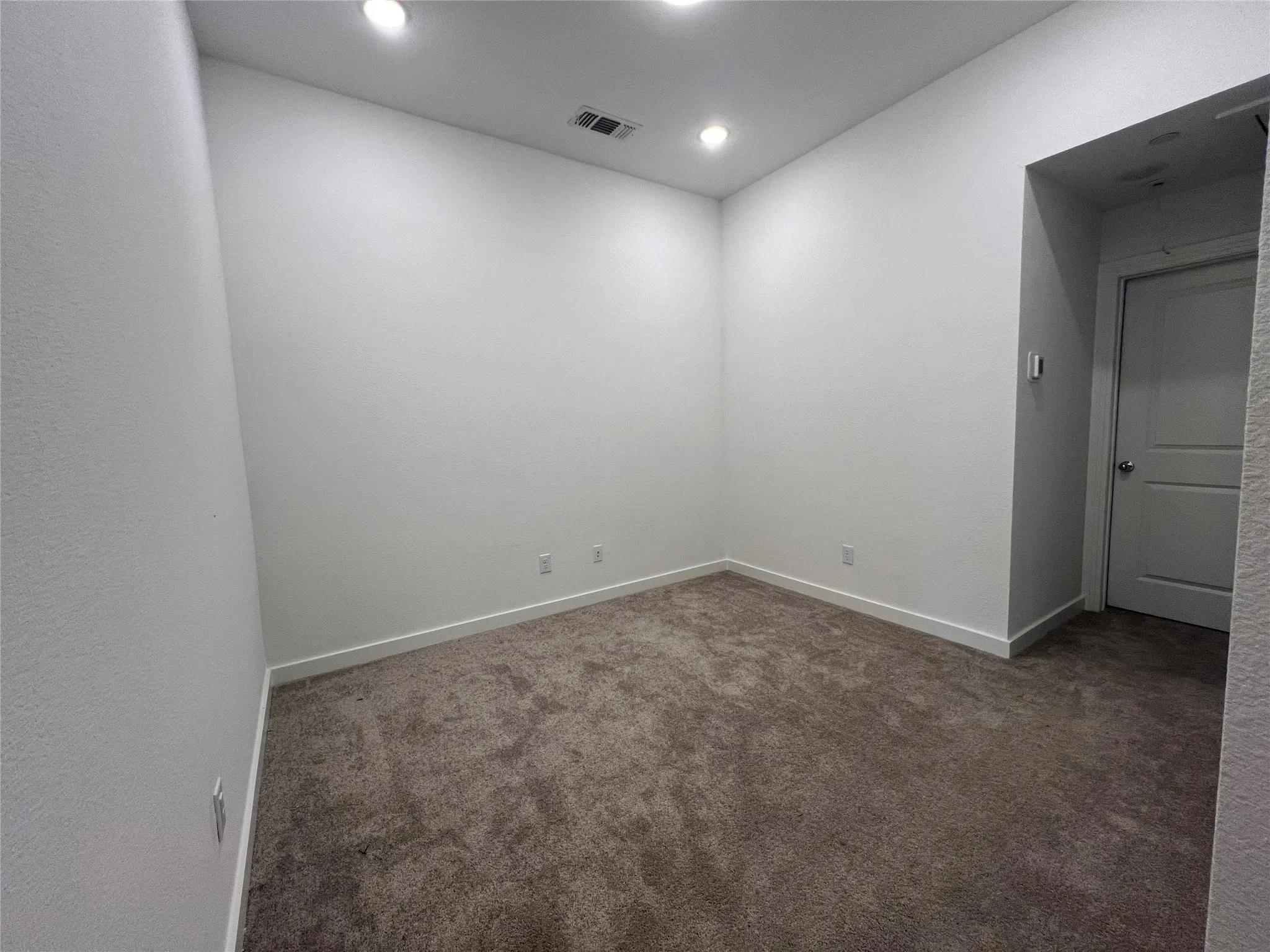 Unfurnished room with dark carpet
