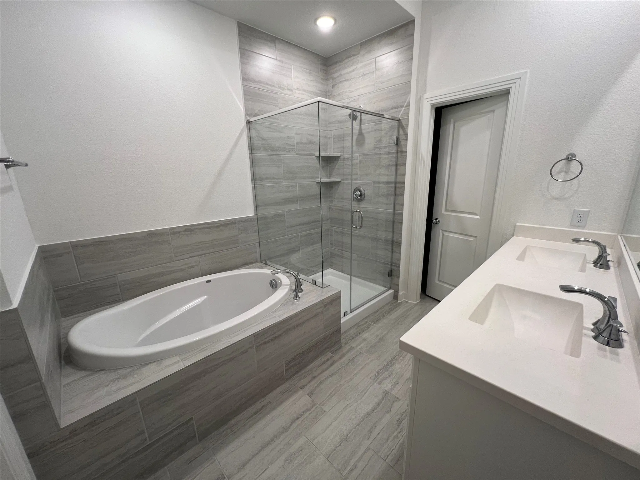 Bathroom featuring plus walk in shower and double vanity