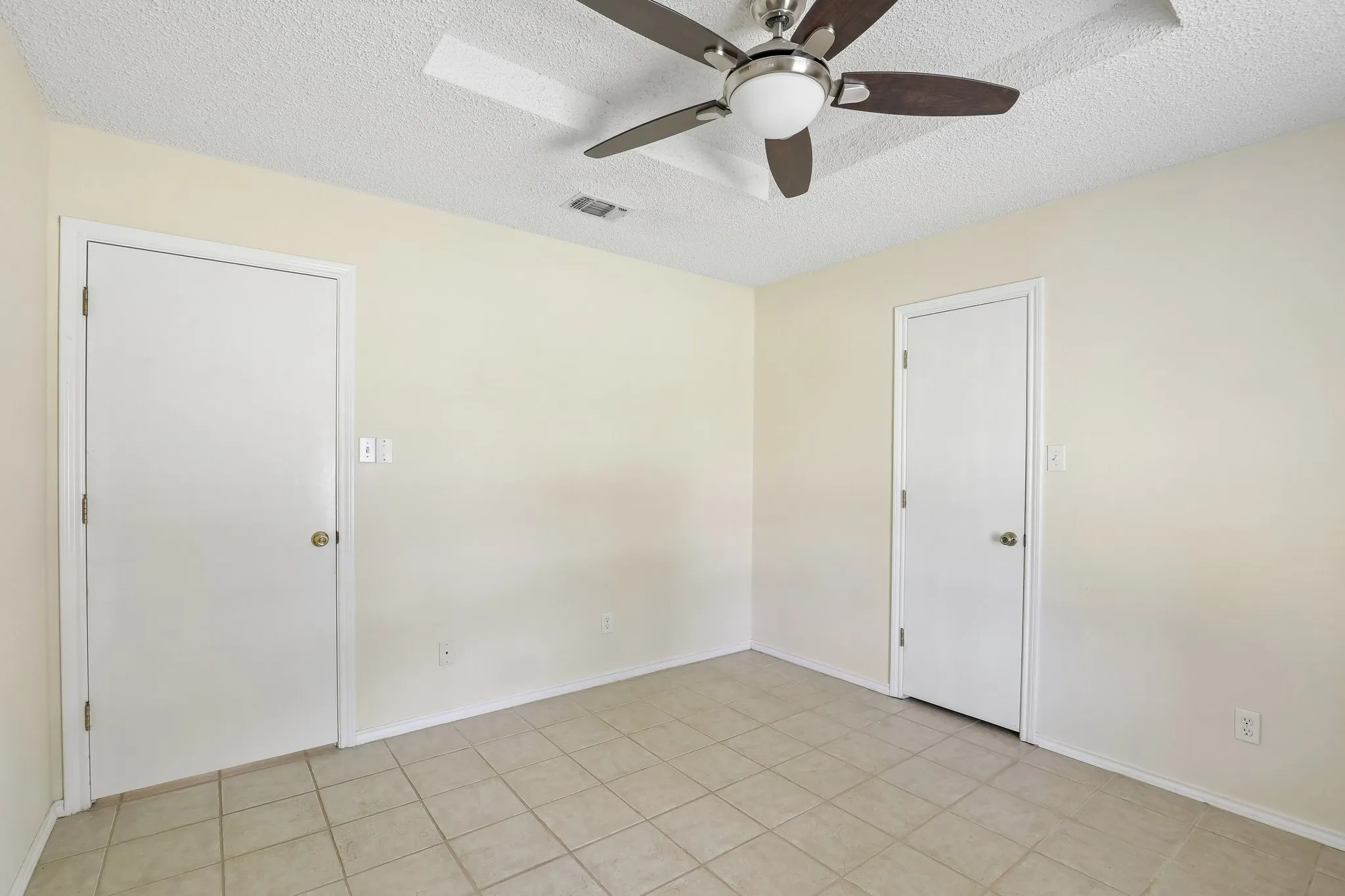 Neutral-toned walls complement the tiled flooring