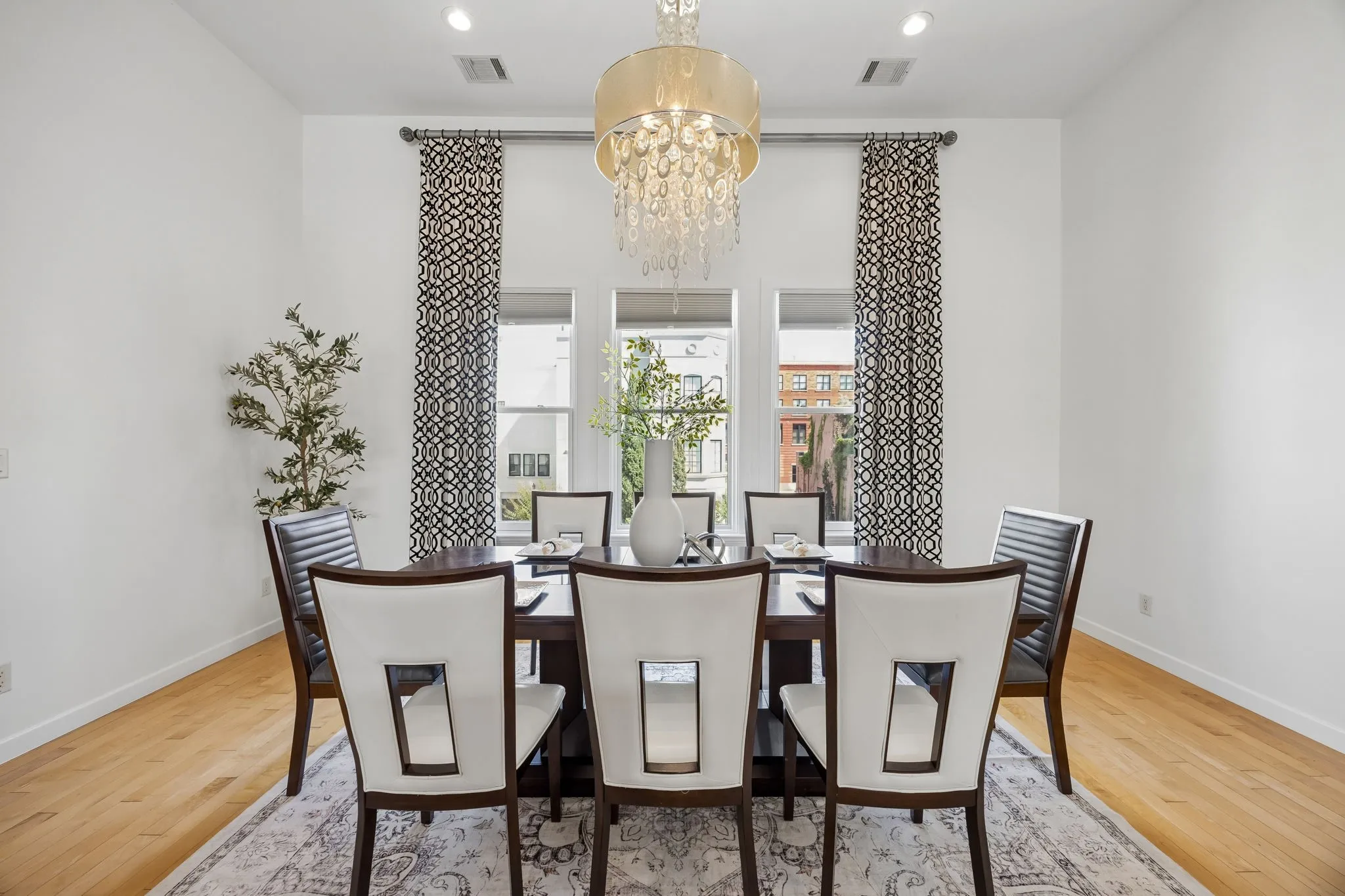 Generous Dining Room With Elegant Chandelier And City Views
