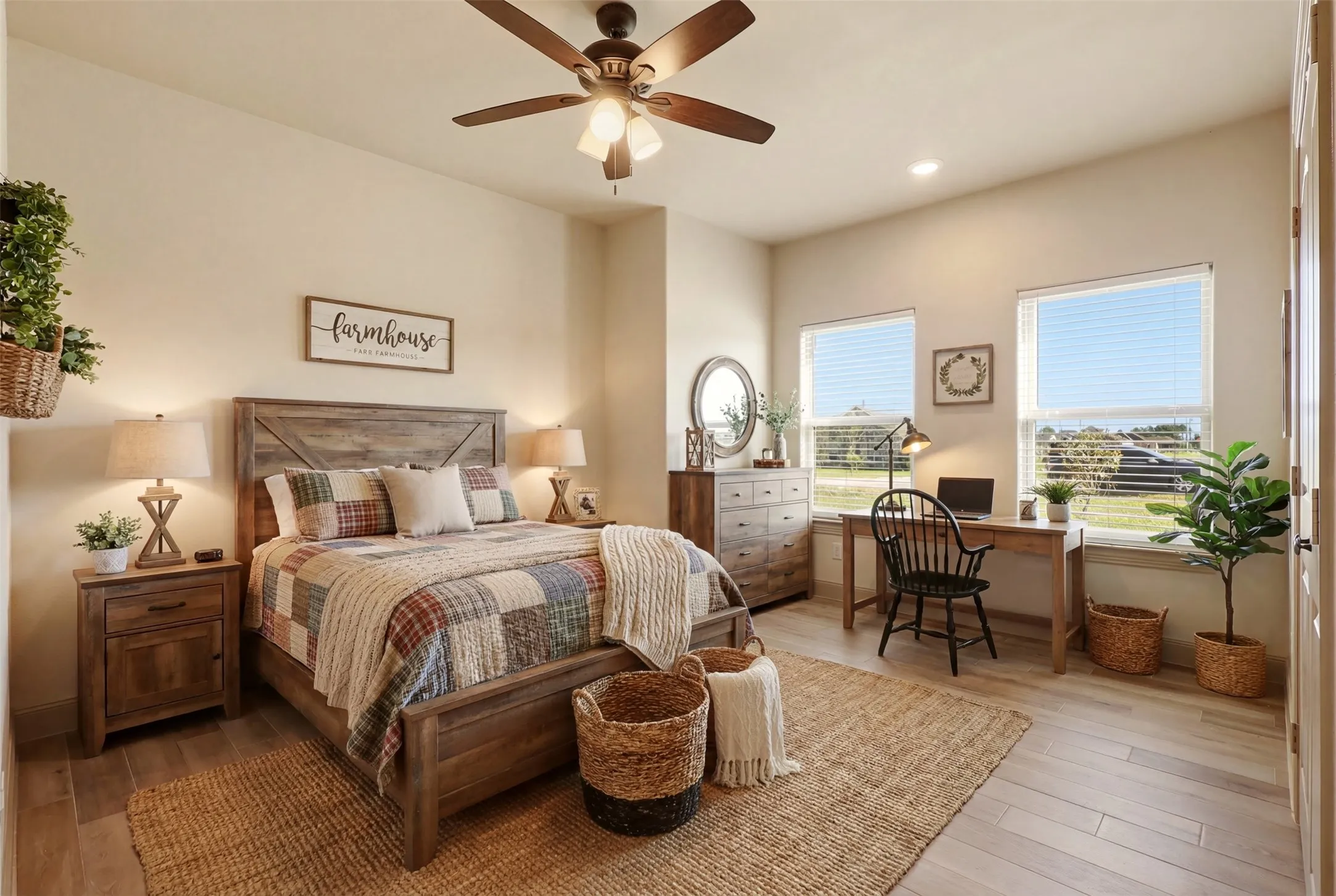 Wood-finish flooring throughout, with a ceiling fan and two windows
