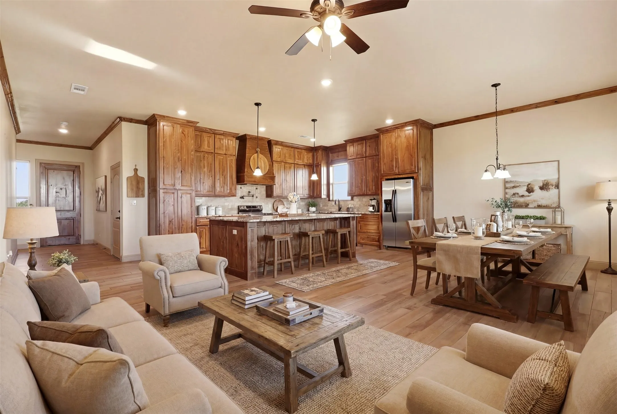 Open-concept living space featuring wood-finish flooring, recessed lighting, and a ceiling fan