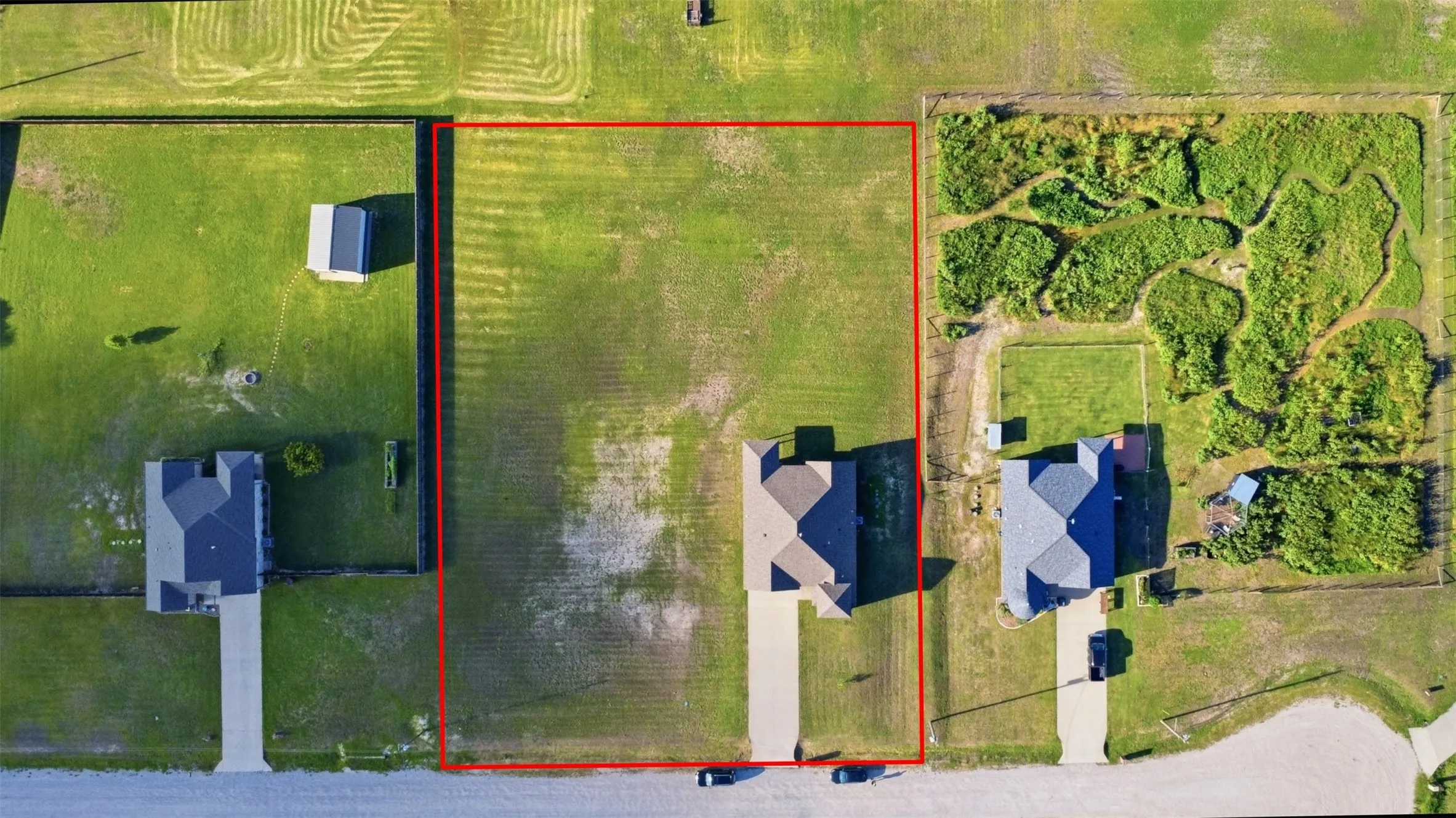 Expansive rectangular lot featuring a level, grass-covered terrain