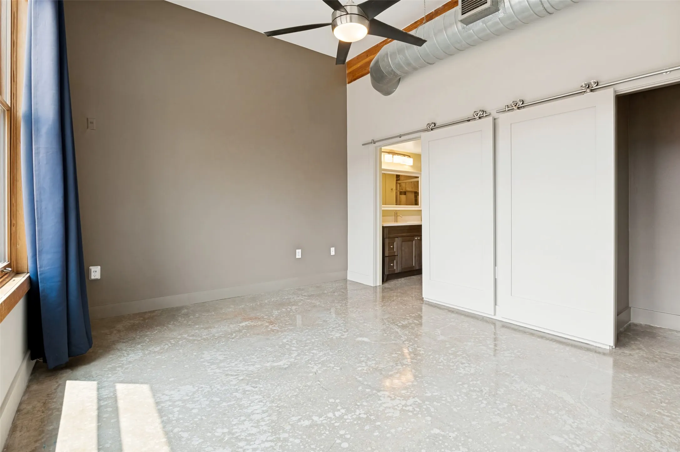 More of the owner's suite that includes barn doors and an accent wall