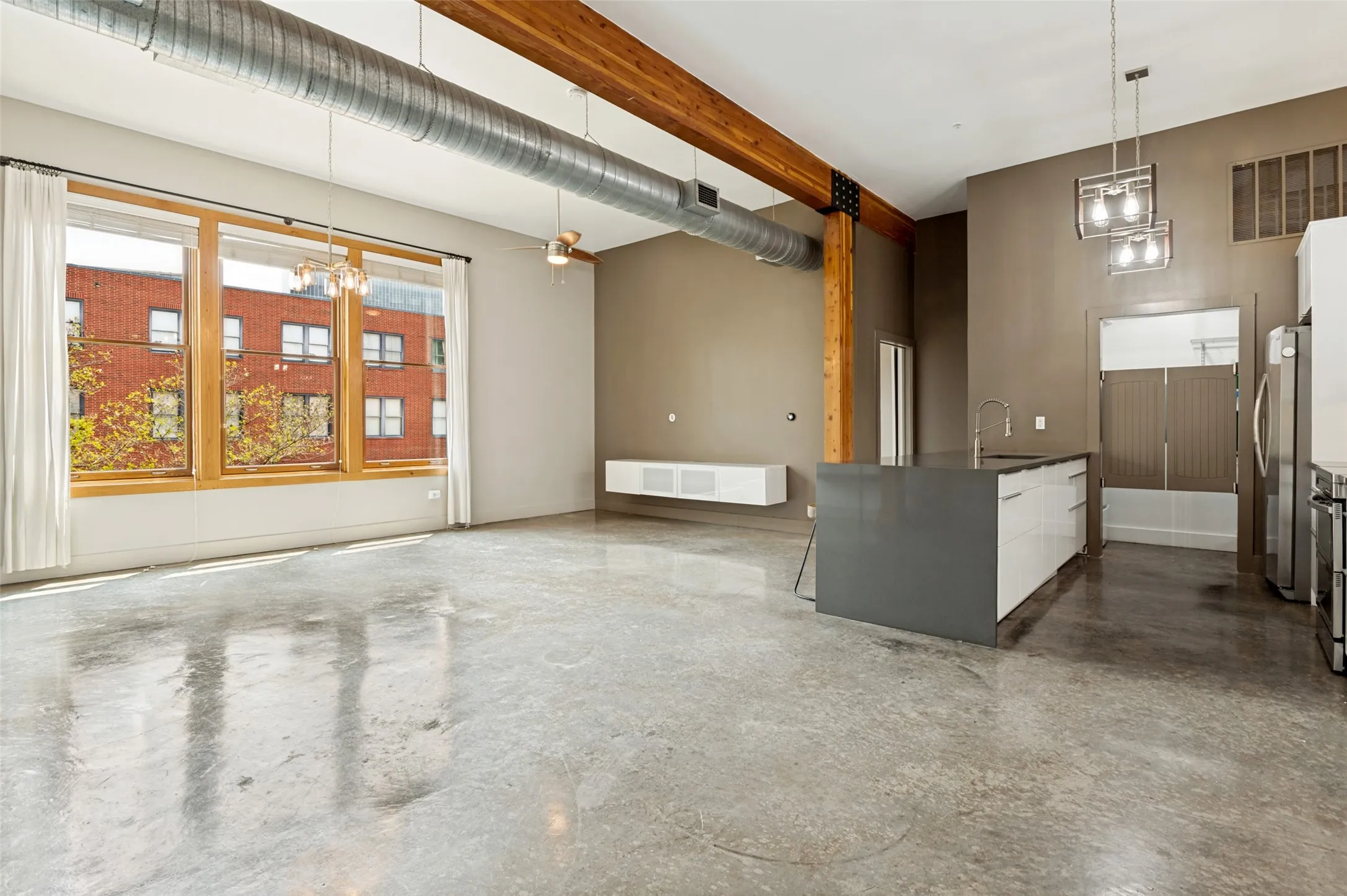 Great room at #208 overlooking pool and interior courtyard