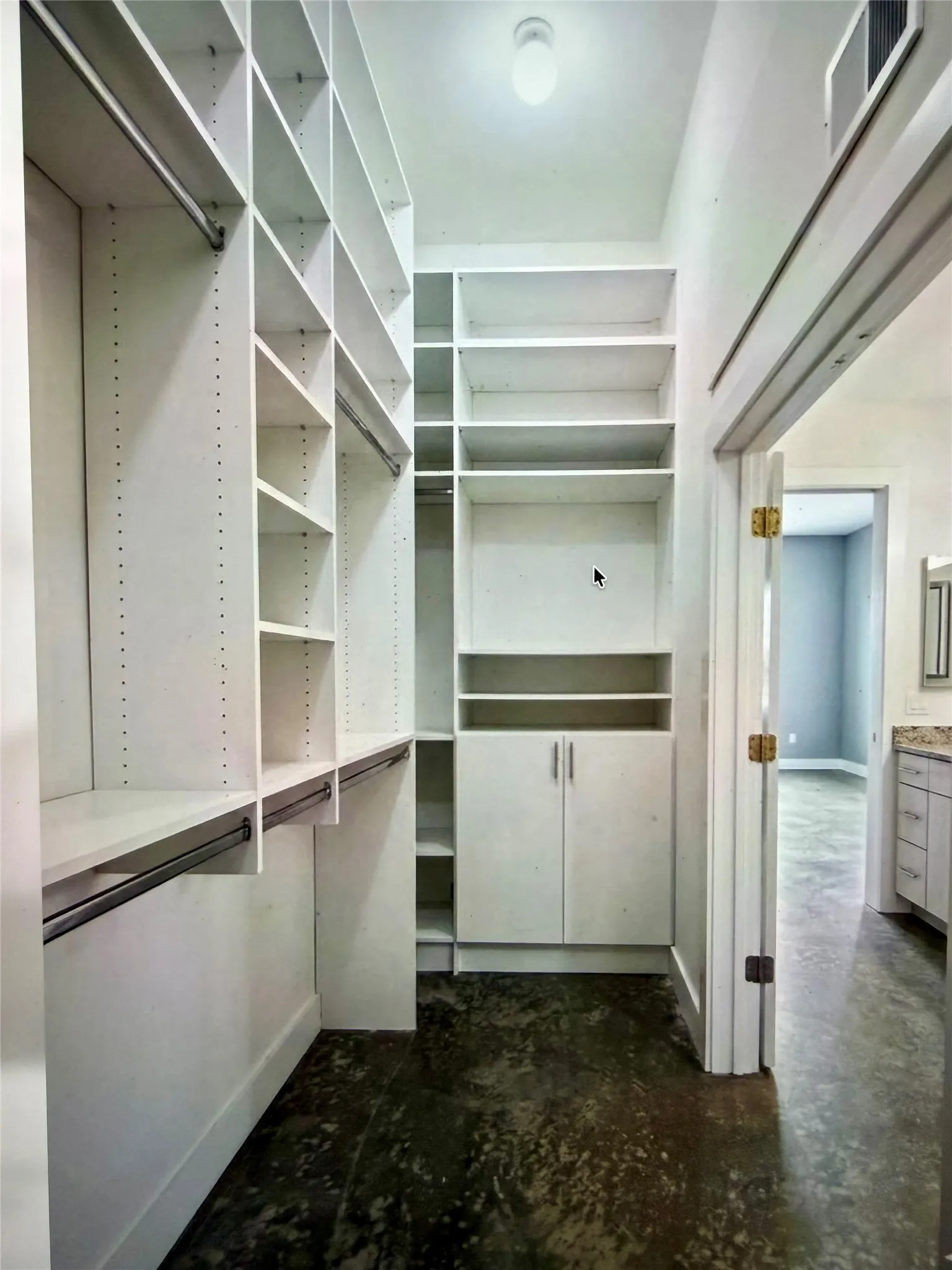 Custom closet system featuring extensive shelving, hanging rods, and built-in cabinetry