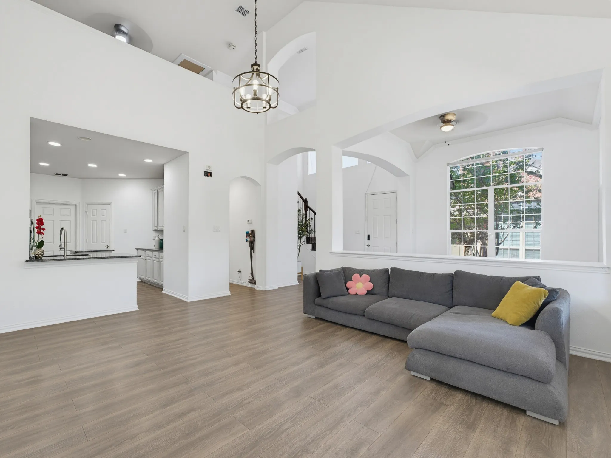 Vaulted ceilings, wood-finish flooring, and an open-concept layout