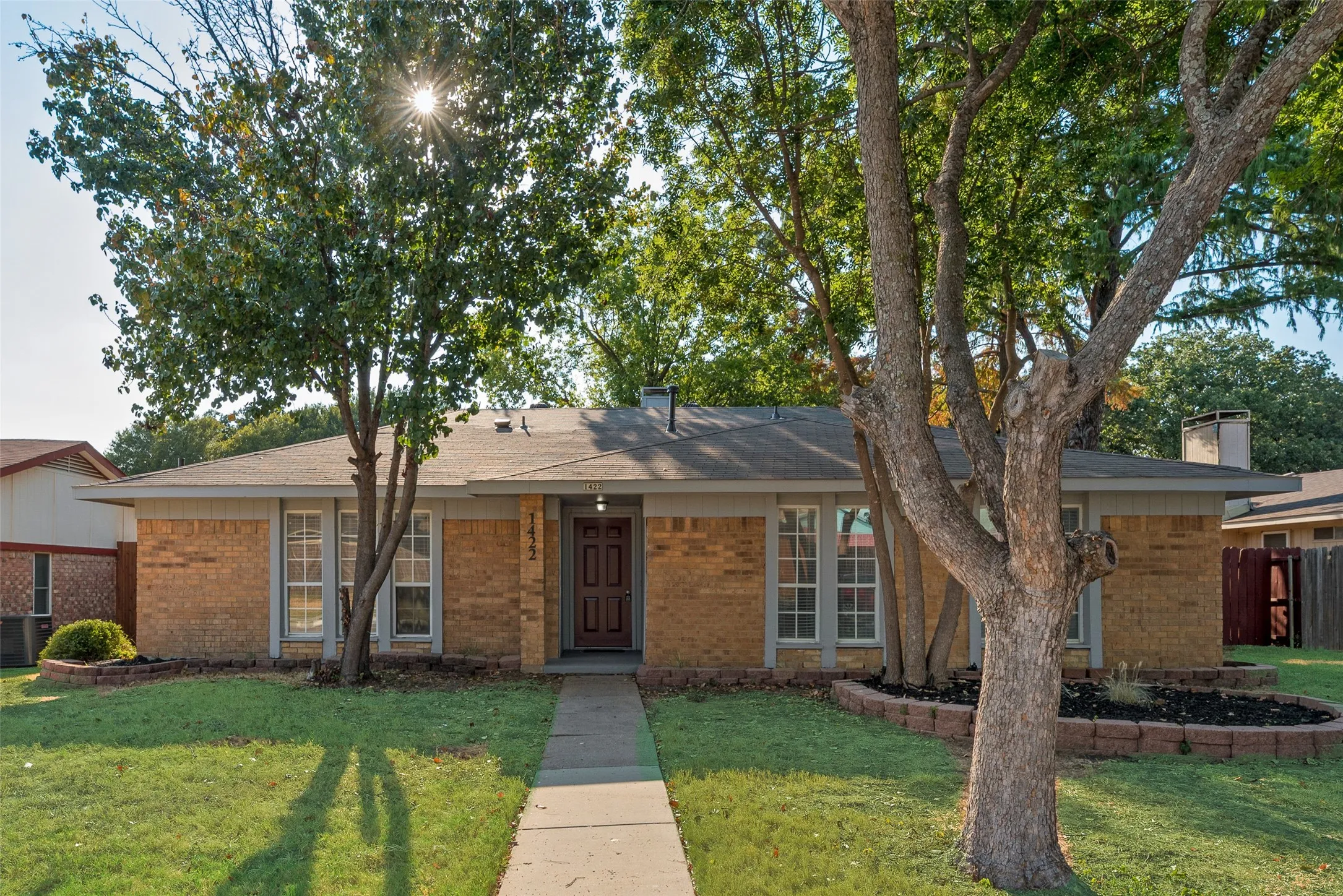 Brick exterior construction with a dark paneled entry door