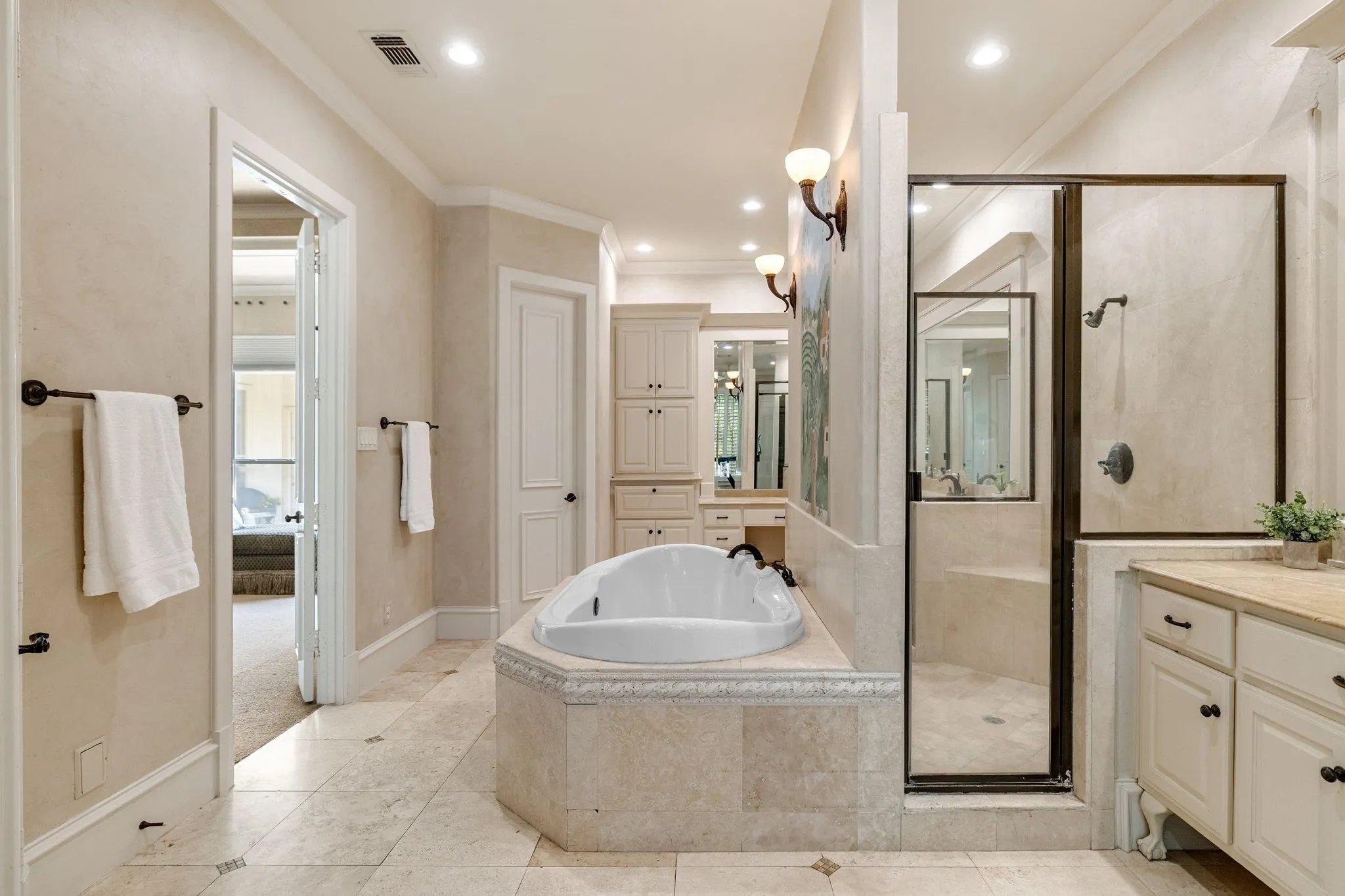 En-suite bath with soaking tub and oversized shower.