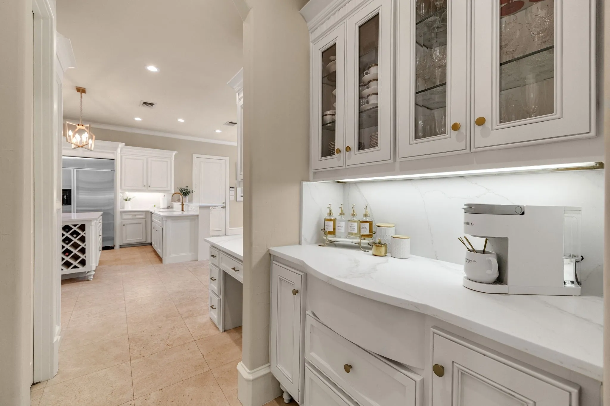Kitchen features butler's panty with glass front cabinetry.