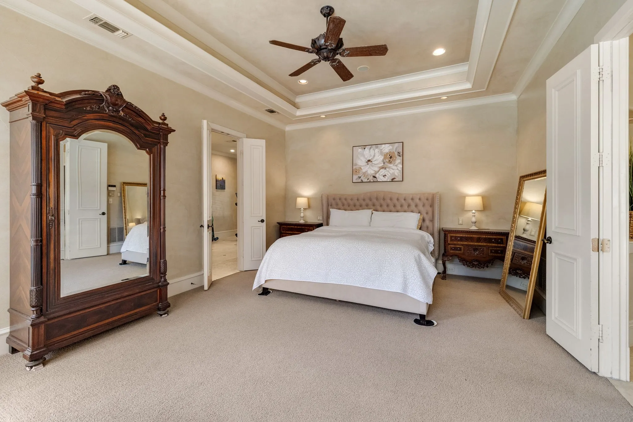 Primary suite features trey ceiling and sitting area.