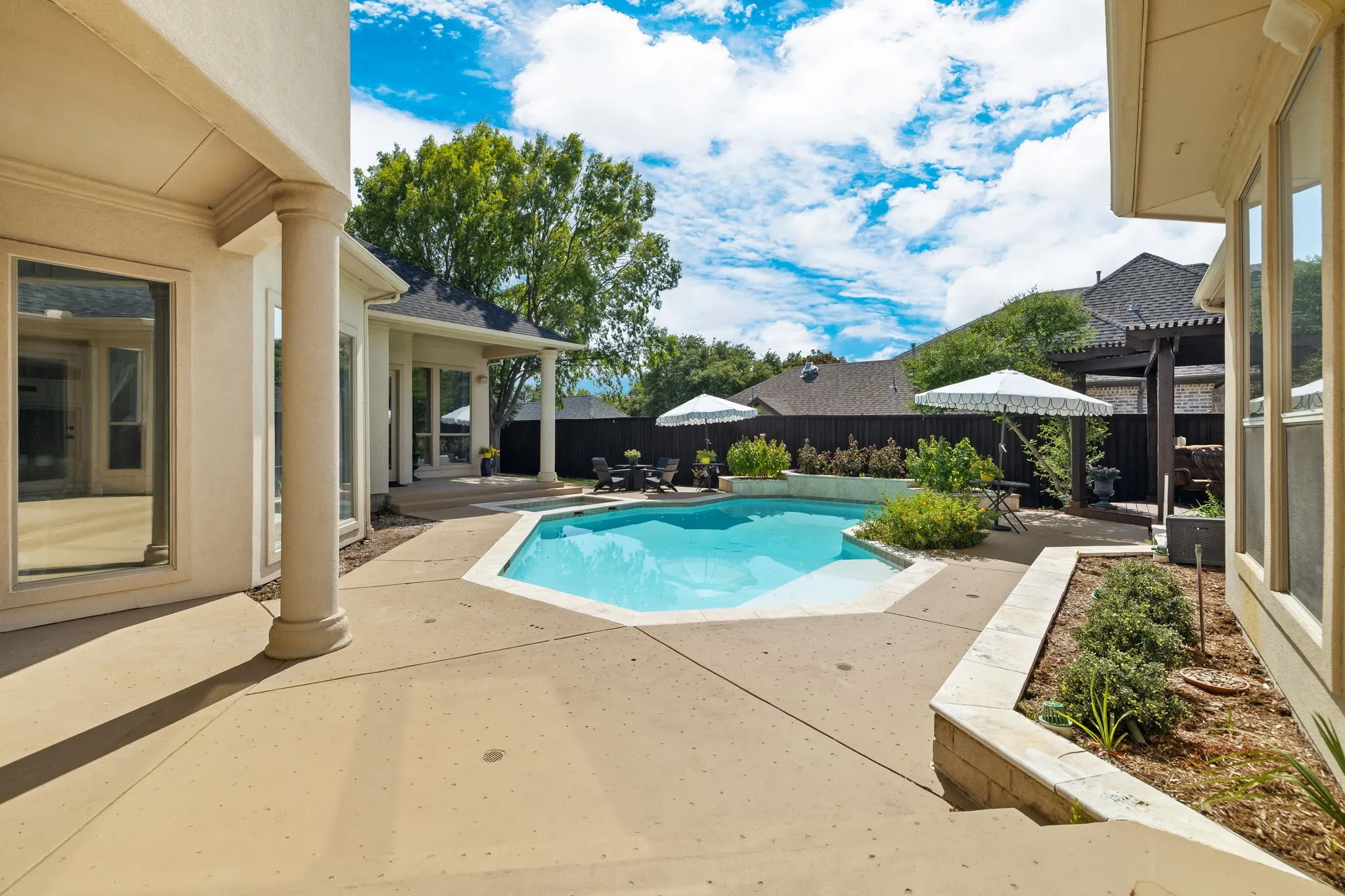 Step outside to your outdoor oasis with multiple patios and sparkling pool.