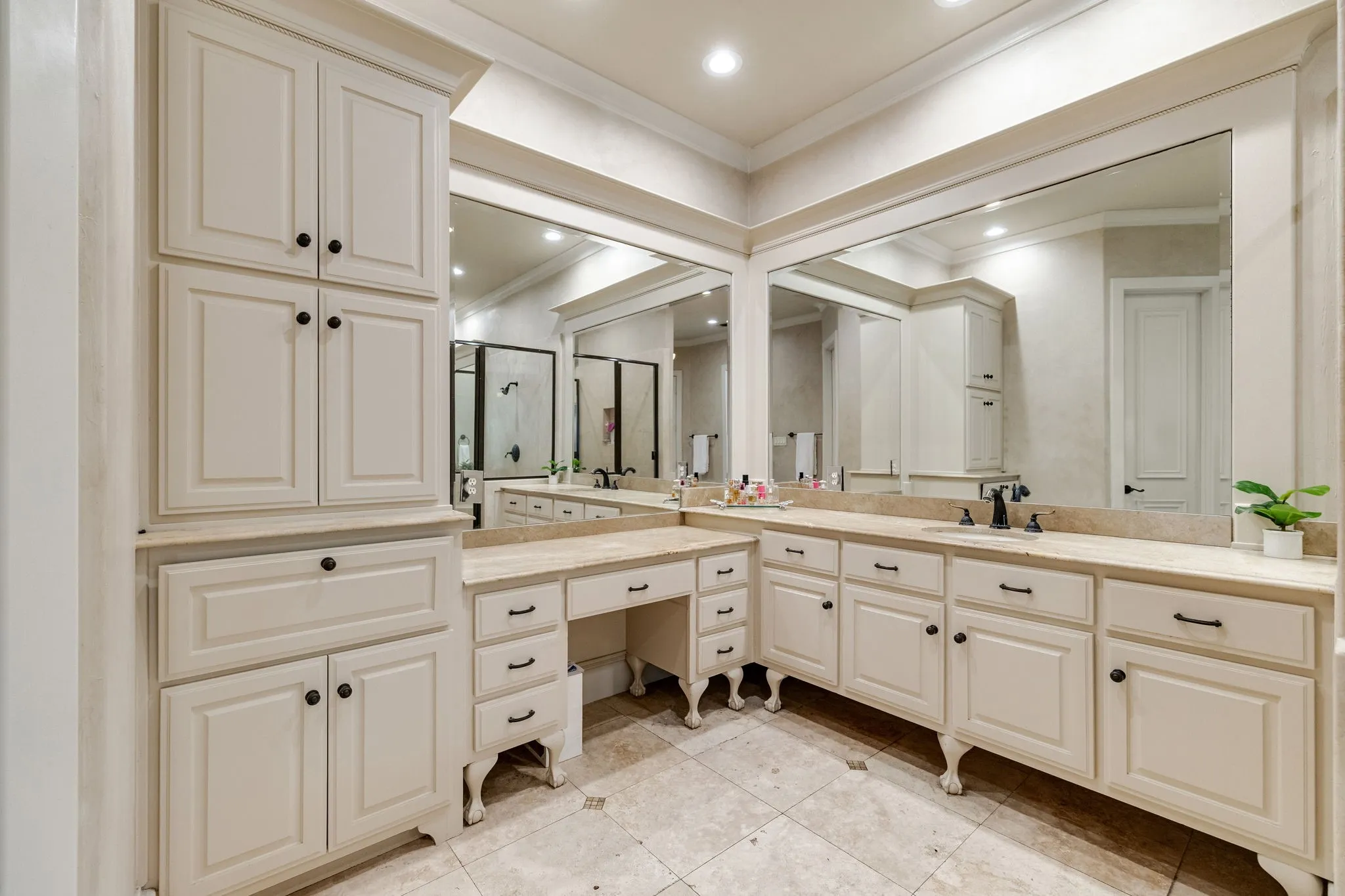 En-suite bath with tons of storage and vanity sitting area.
