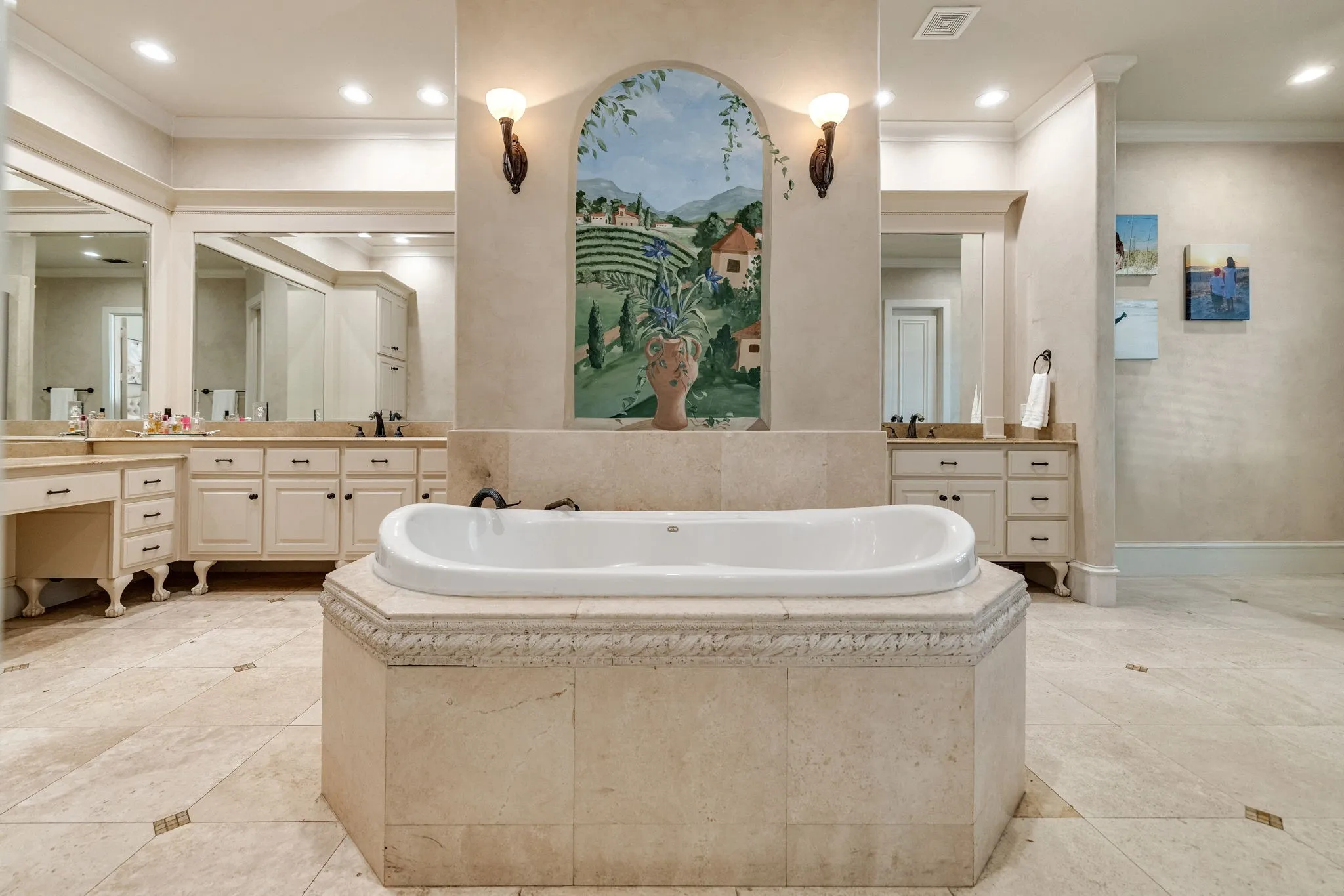 En-suite bath with 2 vanity areas split by soaking tub and oversized shower.