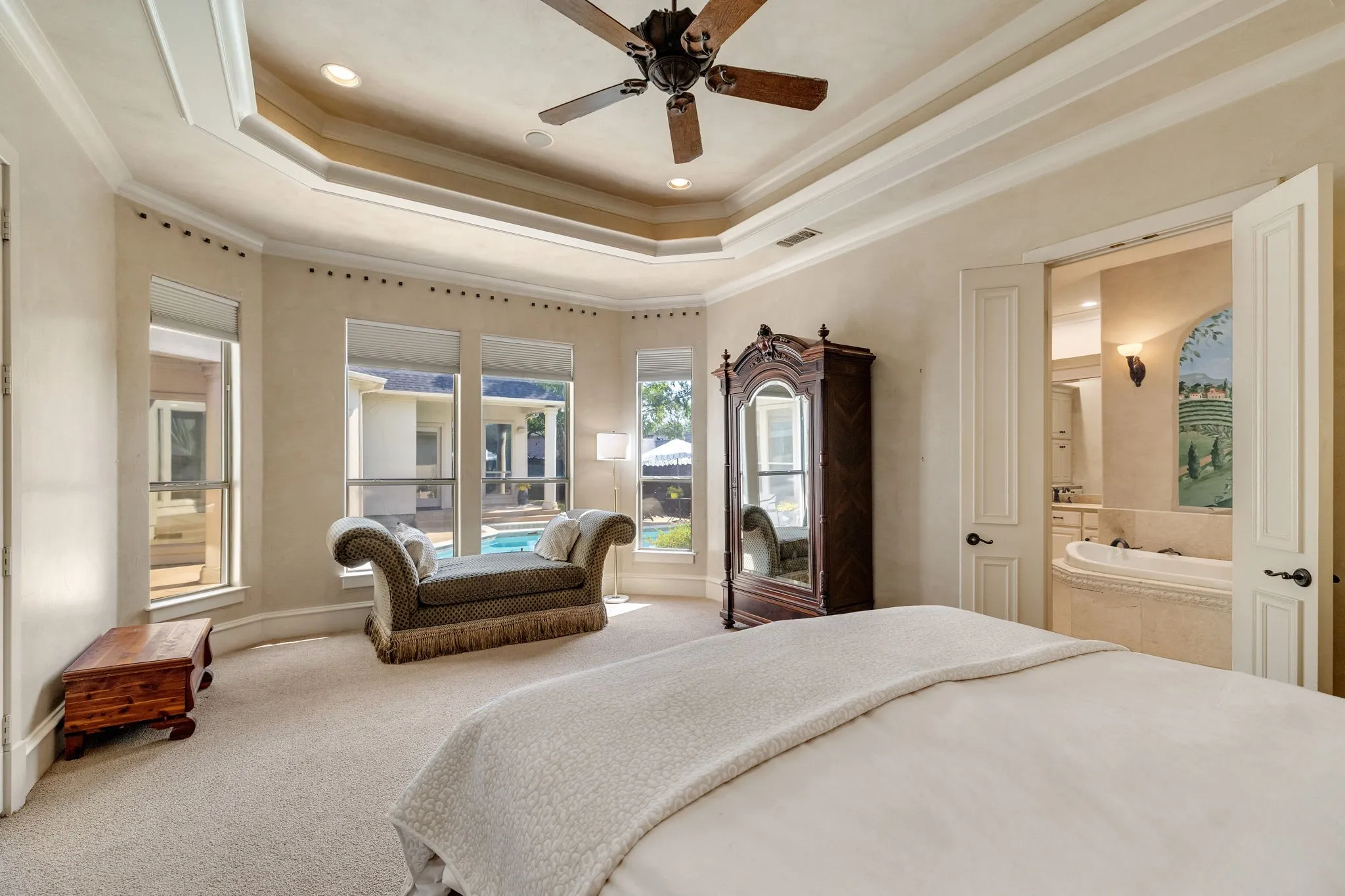 Primary suite with sitting area and double-door entry to en-suite bath.