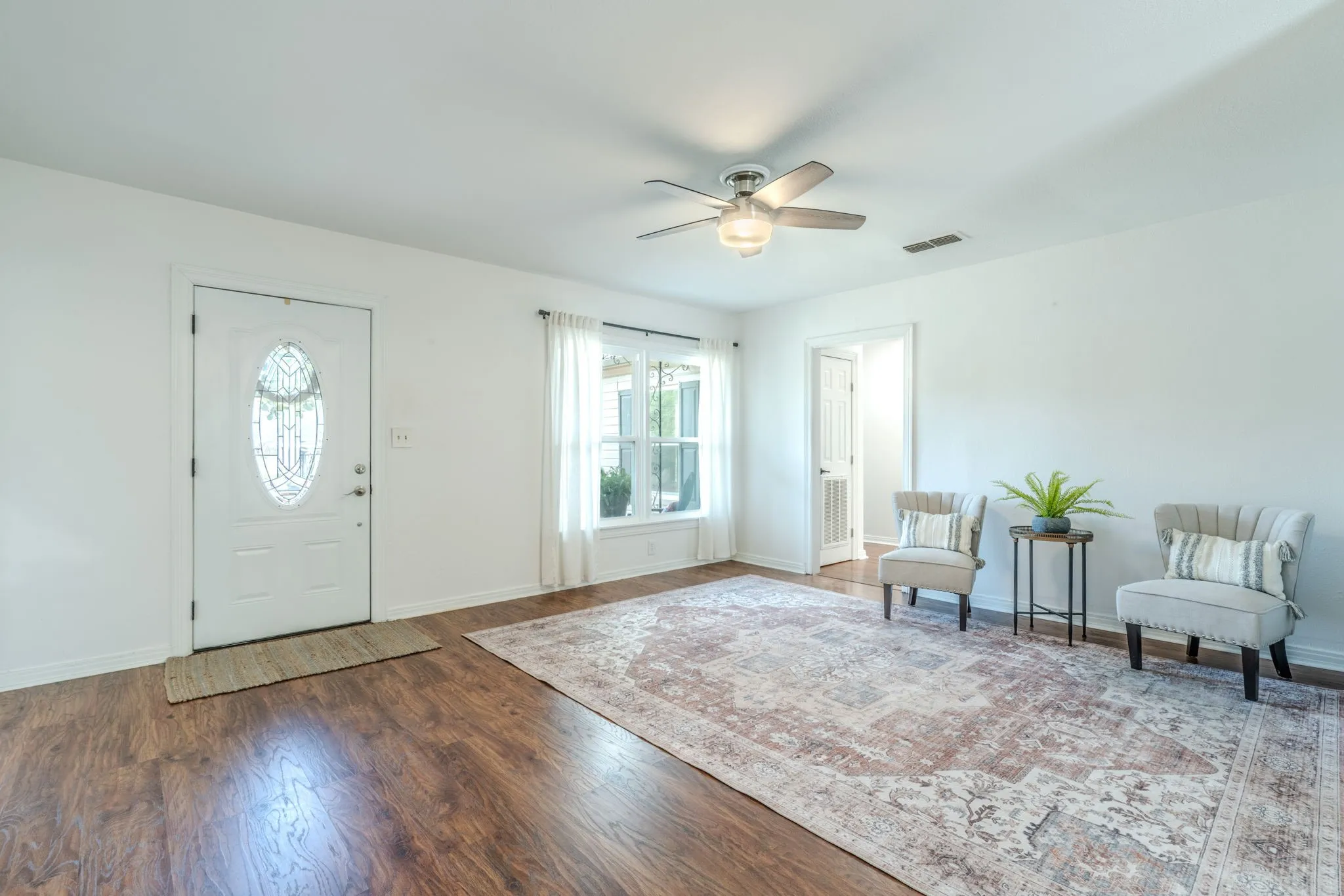 Living room with vinyl wood plank flooring, new Tilt to clean windows