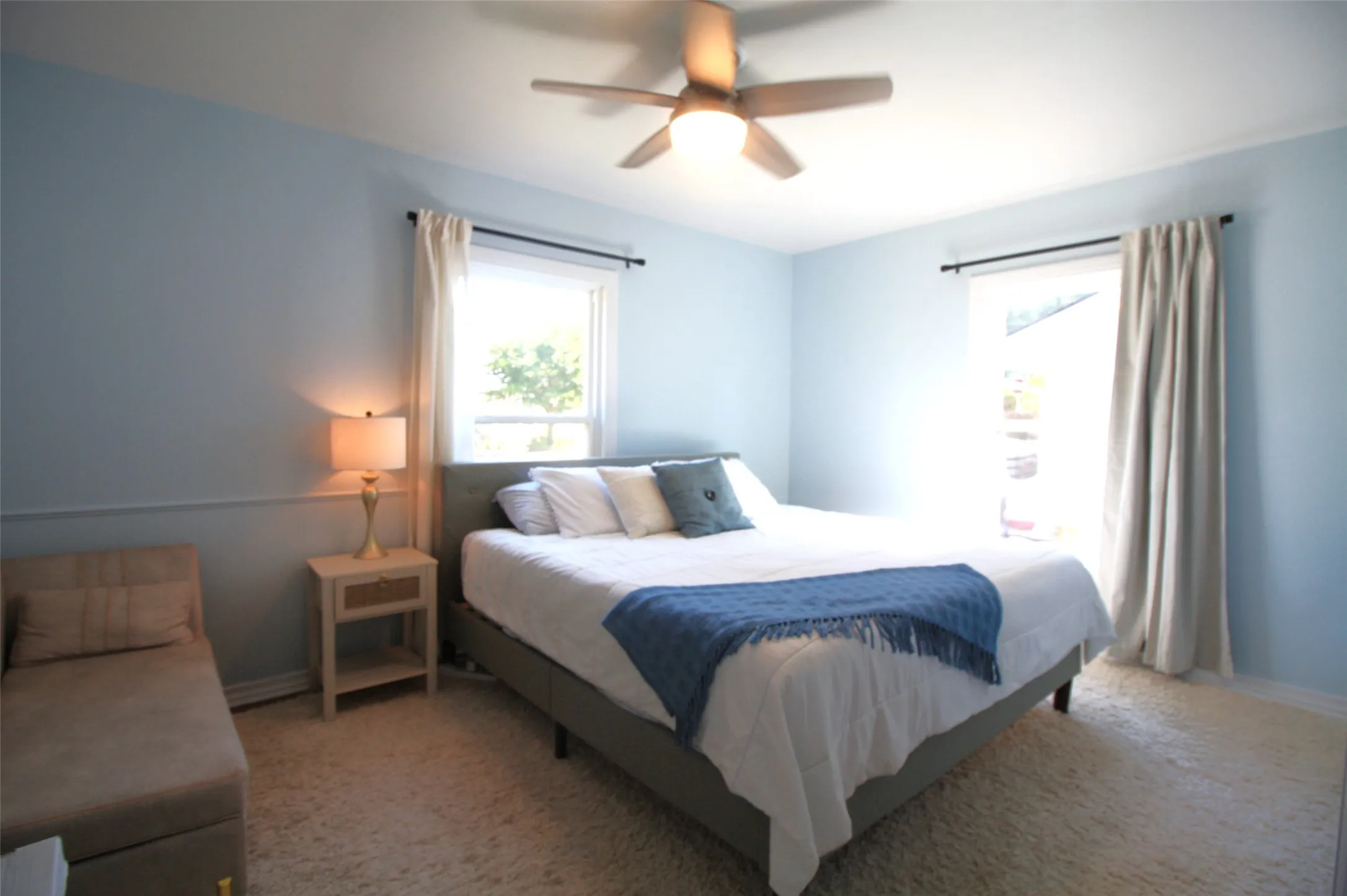 Primary bedroom with king size bed, table and room for large chair