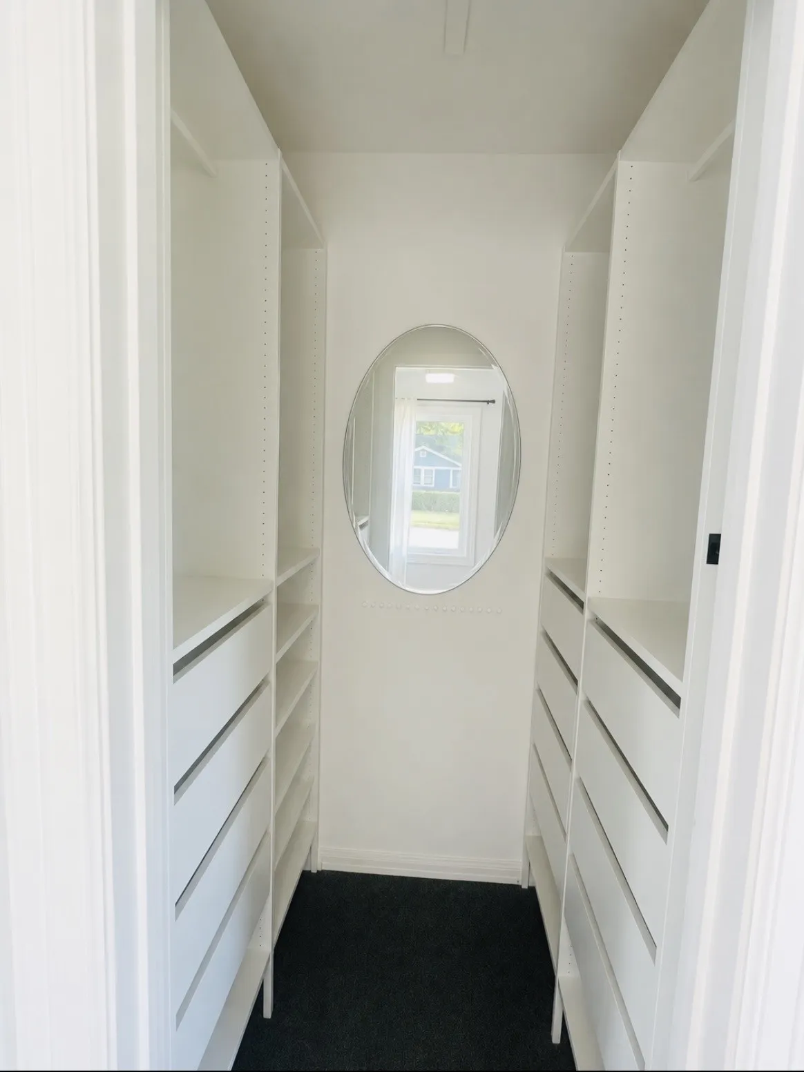 Primary walk in closet with built in shelves