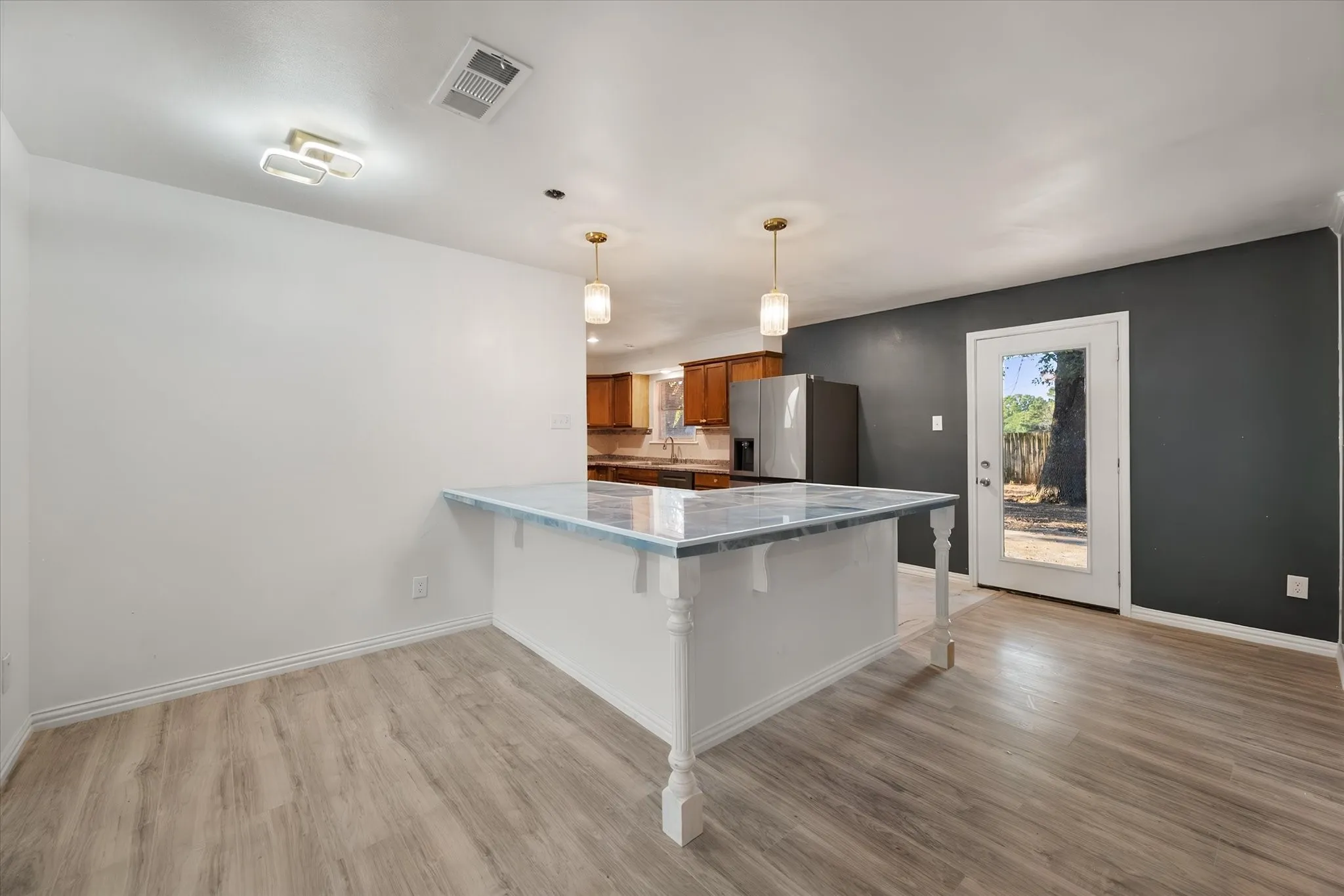 Wood-finish flooring, white walls, and a dark accent wall