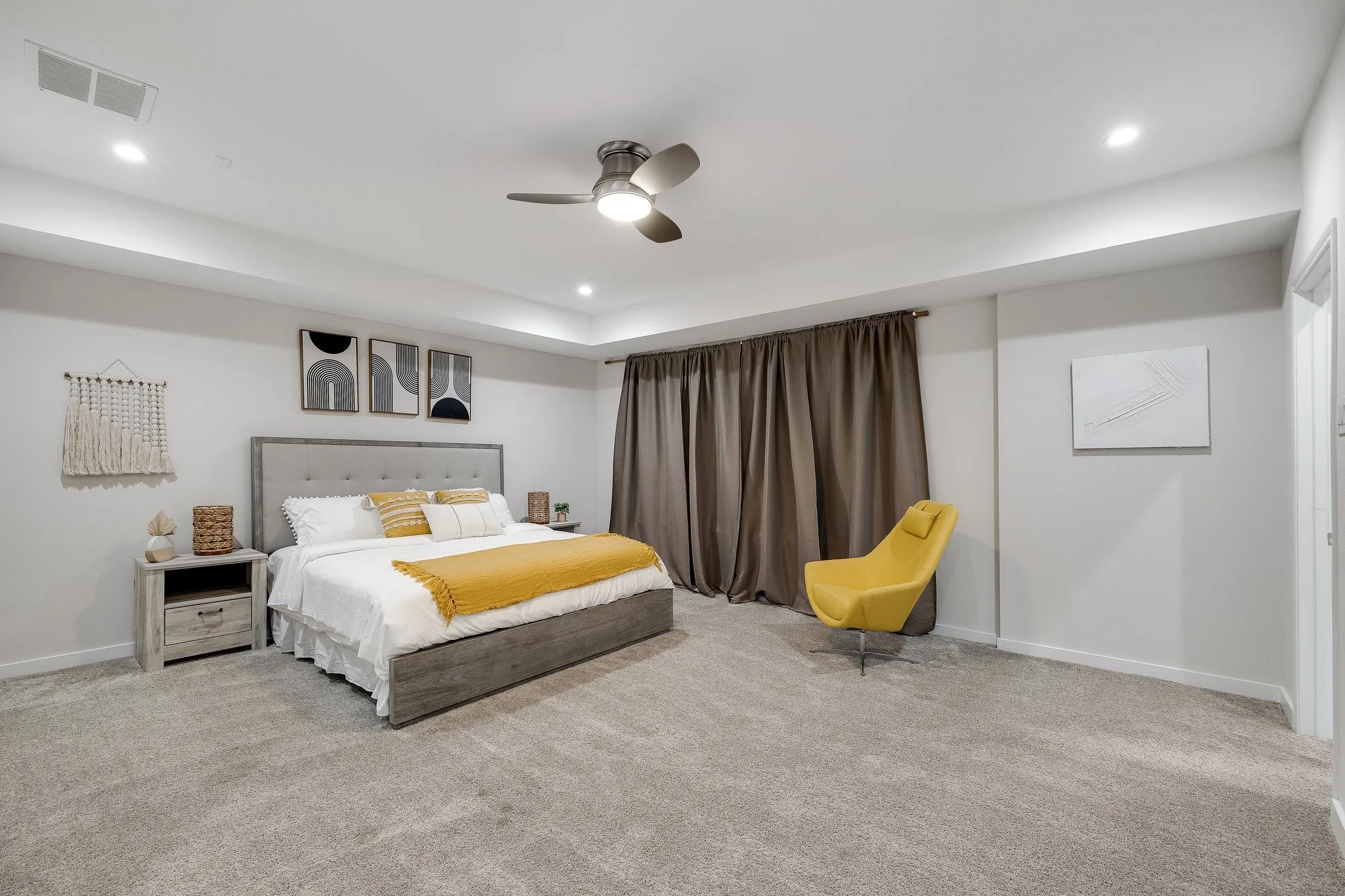 Recessed lighting, ceiling fan fixture, tray ceiling, wall-to-wall carpeting, and neutral wall tones