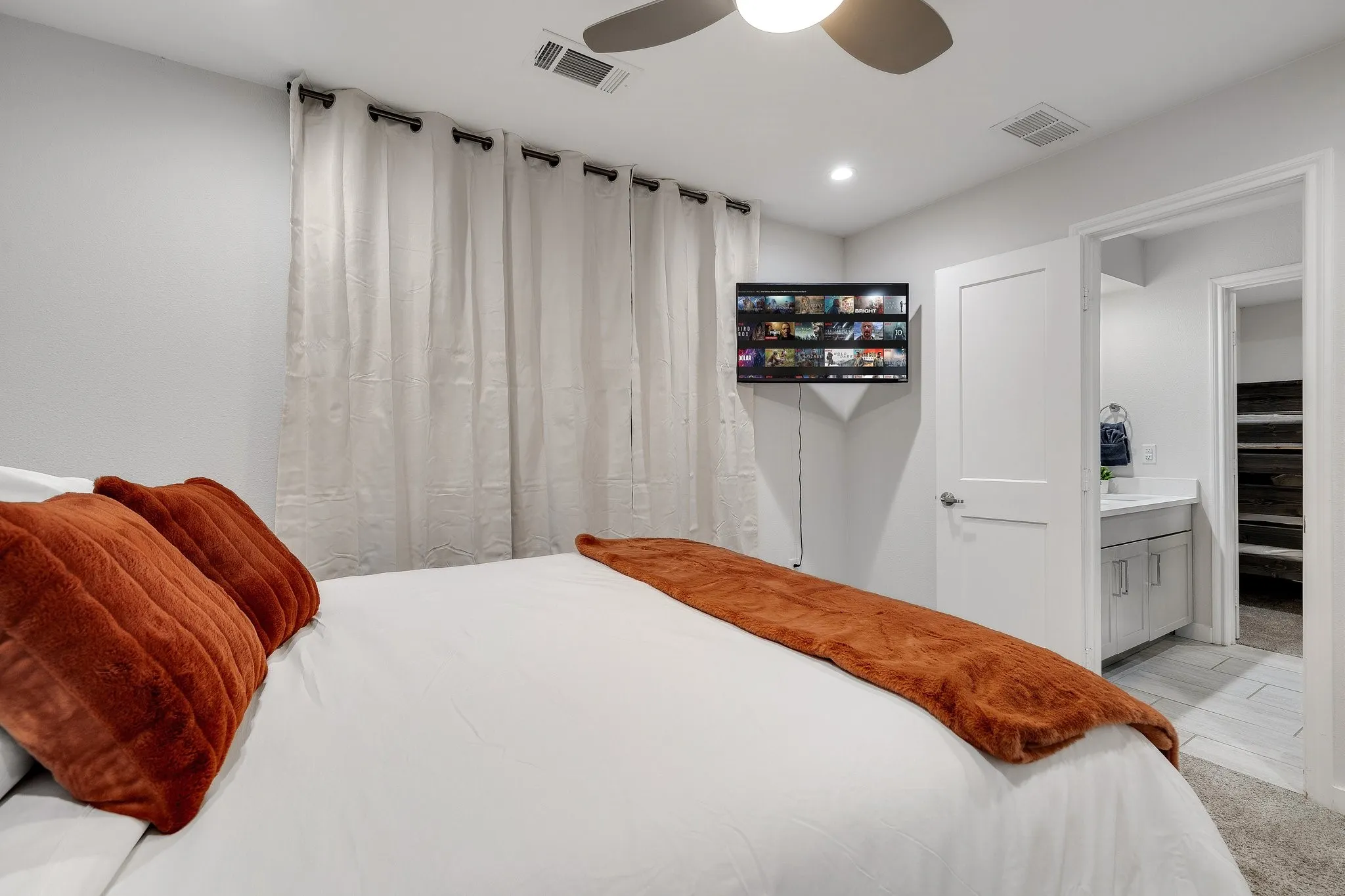 Recessed lighting, ceiling fan, carpet flooring, flat panel door, and vanity with undermount sink