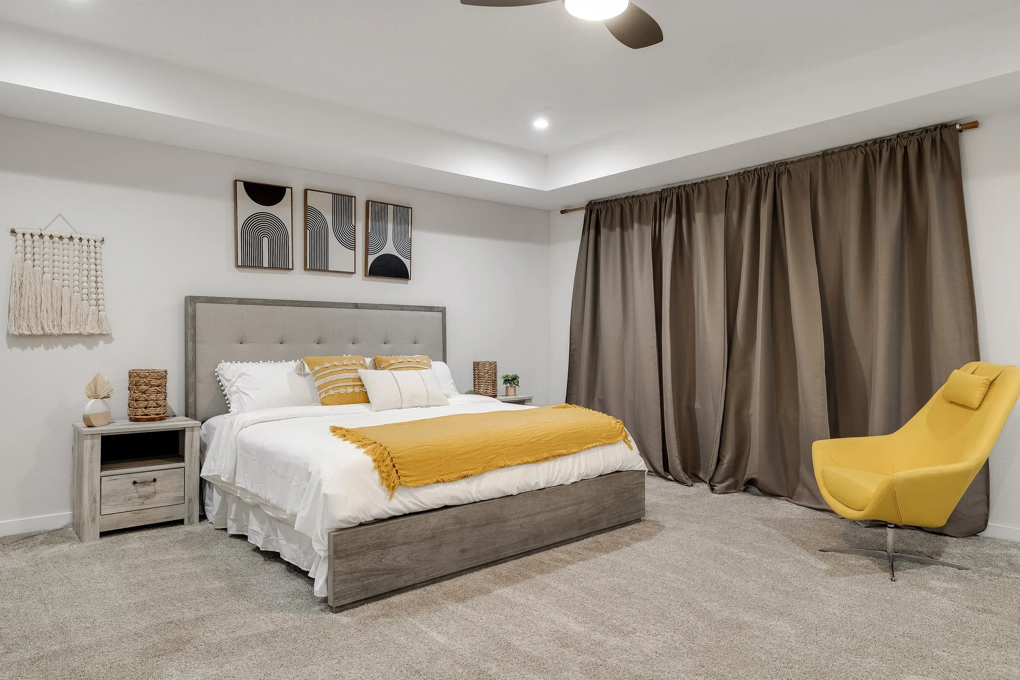 Recessed lighting, ceiling fan, tray ceiling, wall-to-wall carpeting, and full-height window treatments